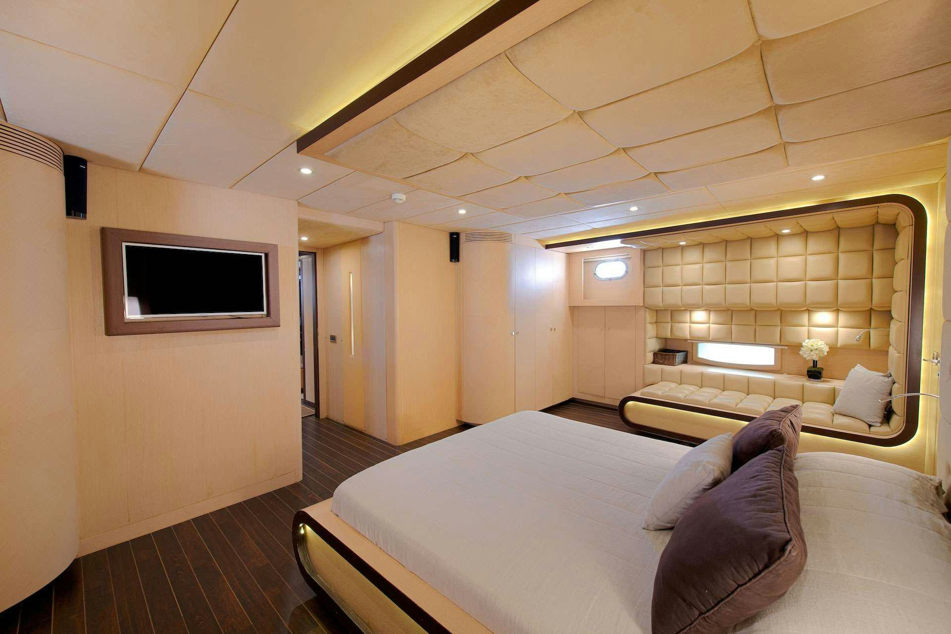 a living room with a couch and a tv aboard THE WALL Yacht for Charter