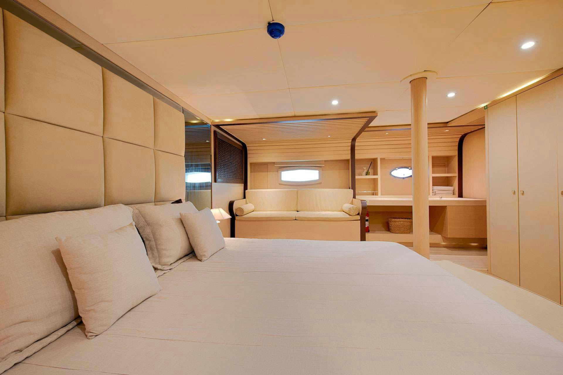 a bed with a white sheet aboard THE WALL Yacht for Charter