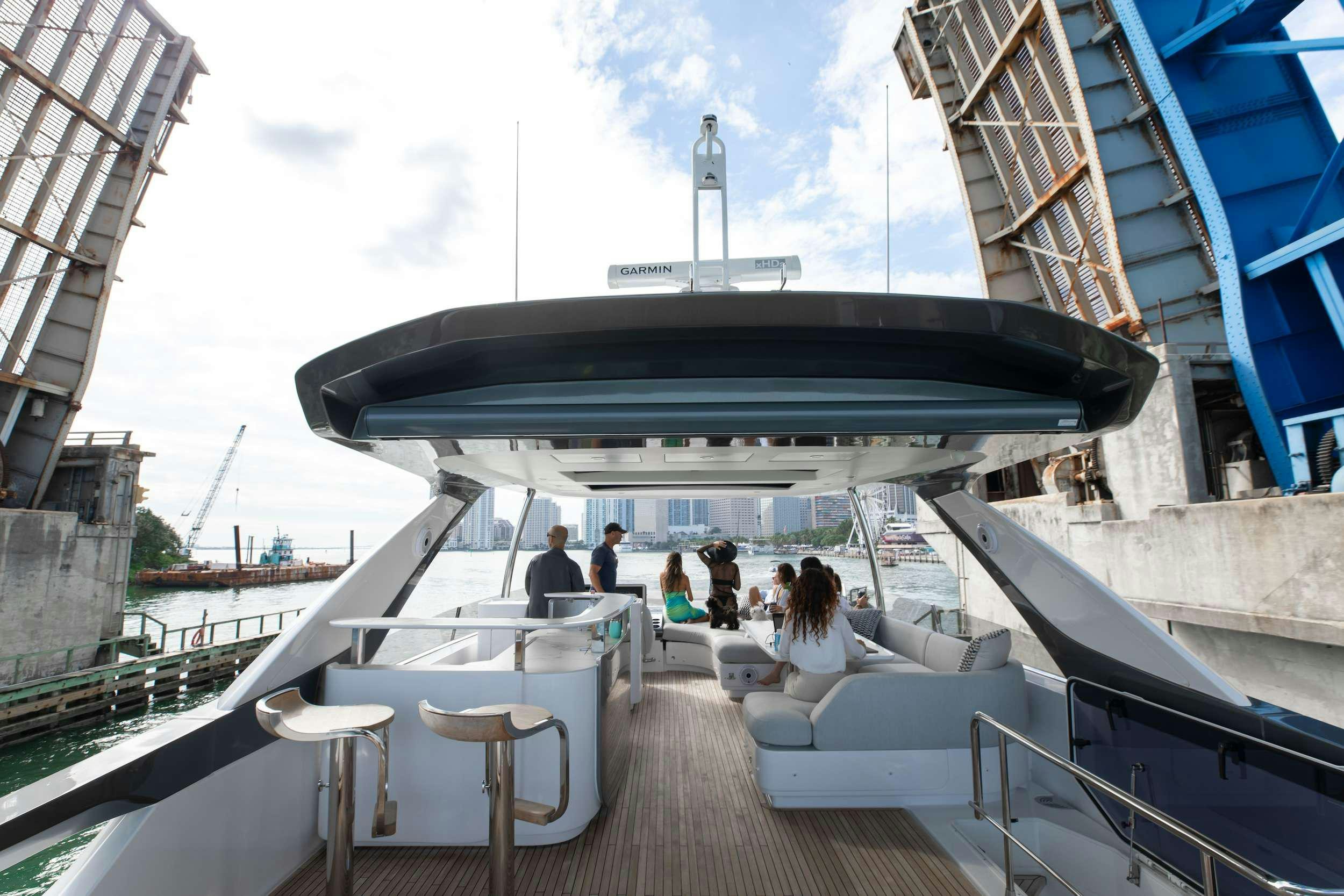 a group of people sitting on a deck on a boat aboard NENA Yacht for Charter