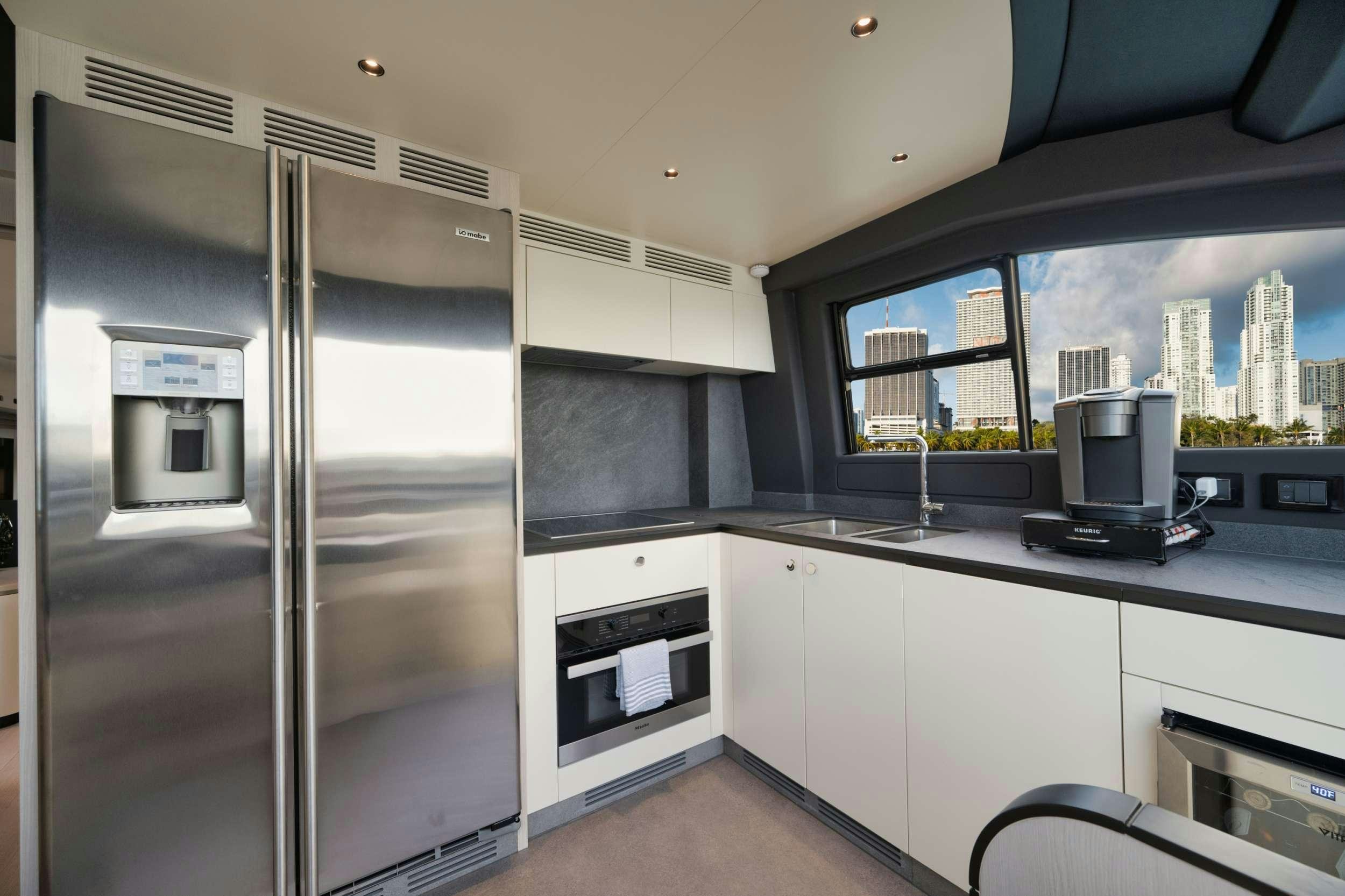 a kitchen with a large glass shower aboard NENA Yacht for Charter