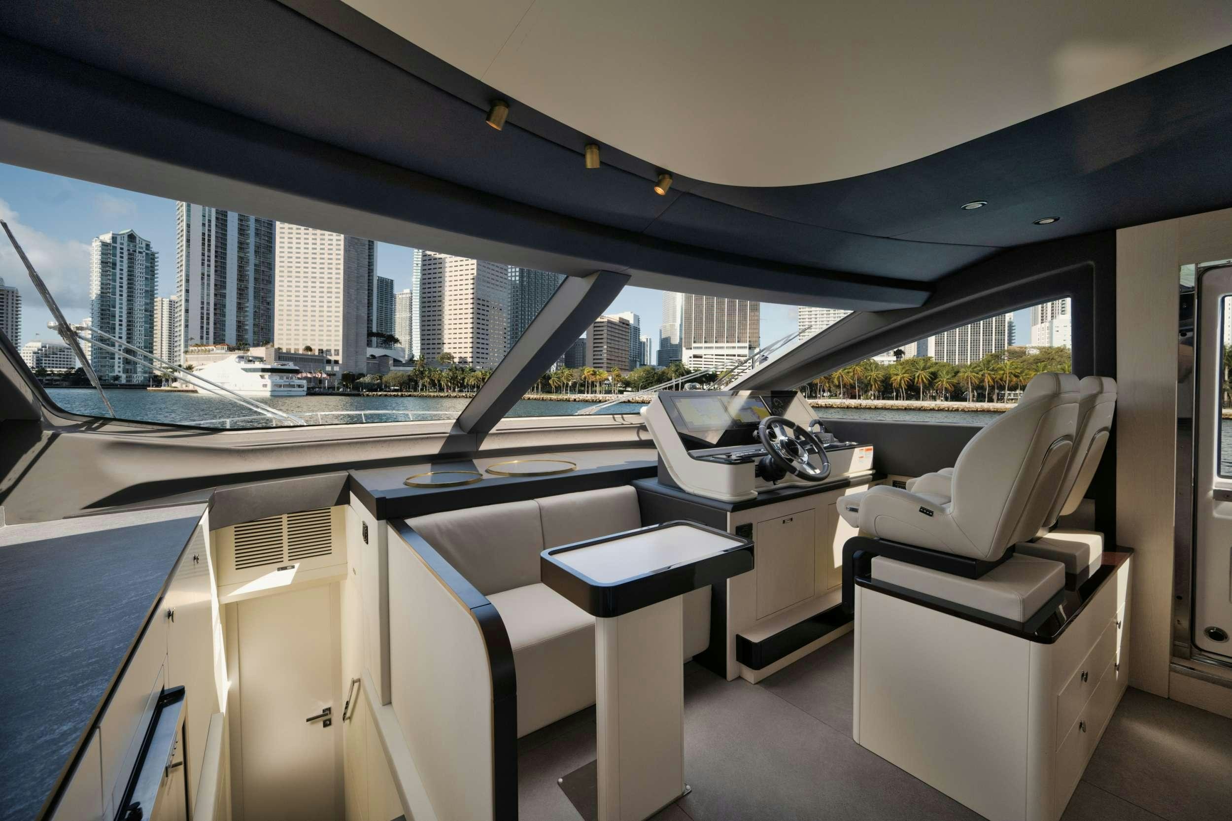 a room with a large window and a view of a city aboard NENA Yacht for Charter