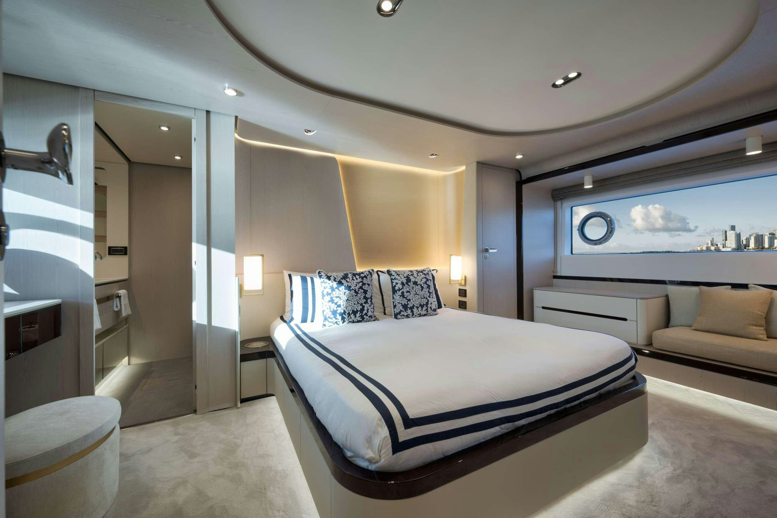 a bedroom with a bed and a large mirror aboard NENA Yacht for Charter