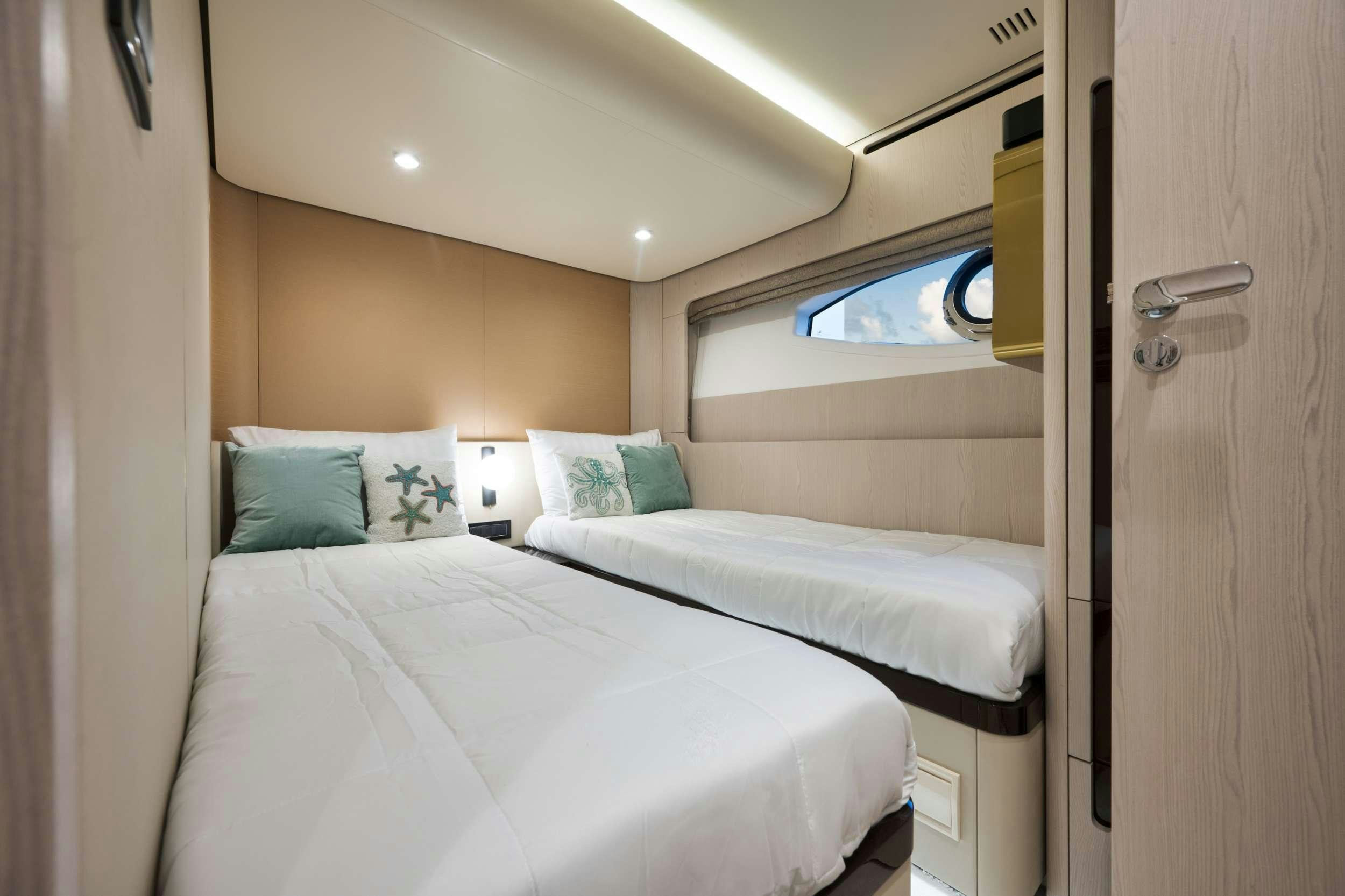 a couple of beds in a room aboard NENA Yacht for Charter