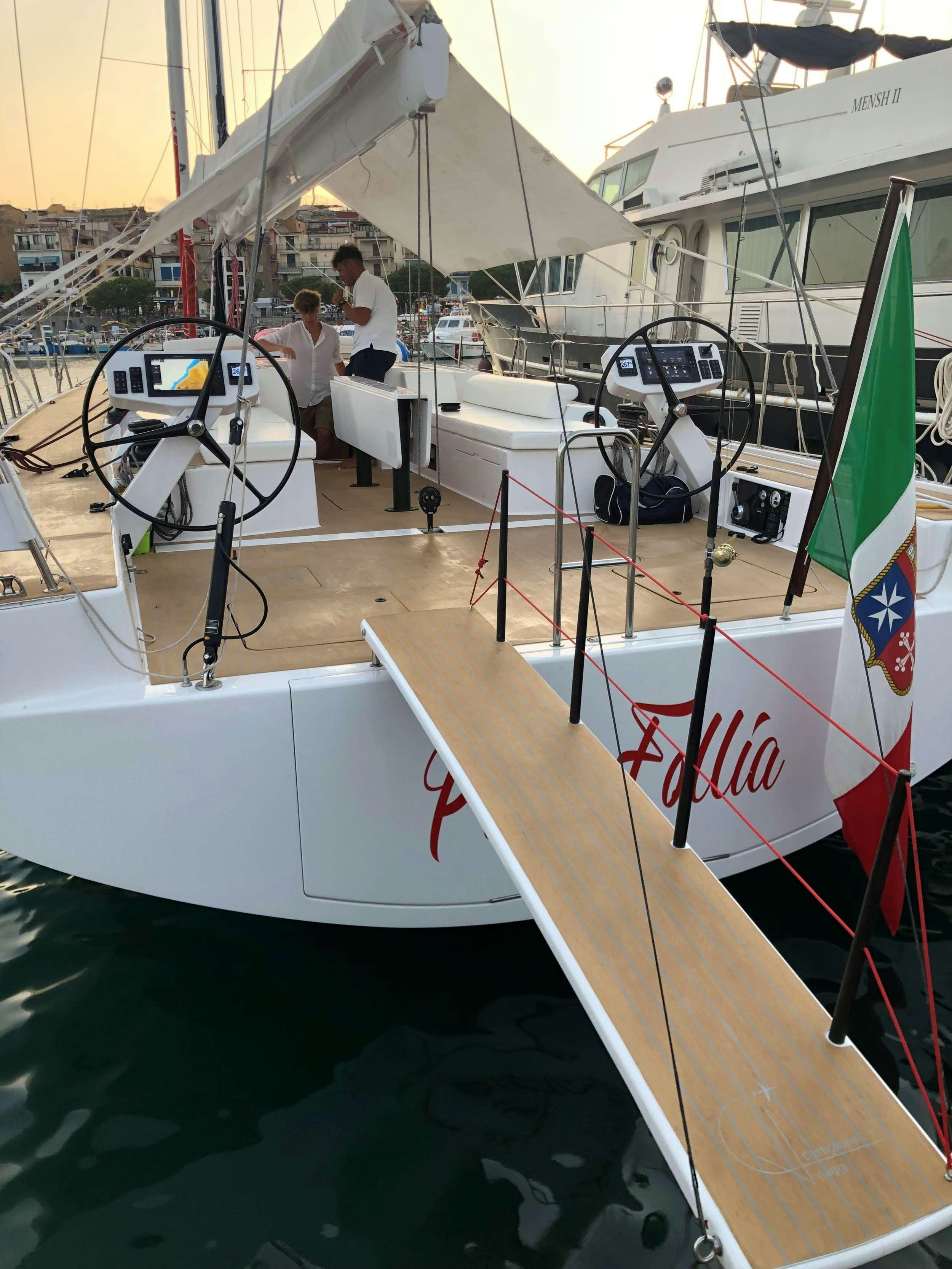 a boat is parked in a harbor aboard PURA FOLLIA Yacht for Charter