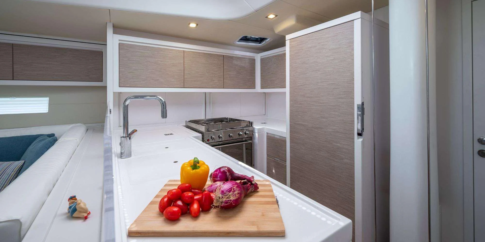 a kitchen with white cabinets aboard PURA FOLLIA Yacht for Charter