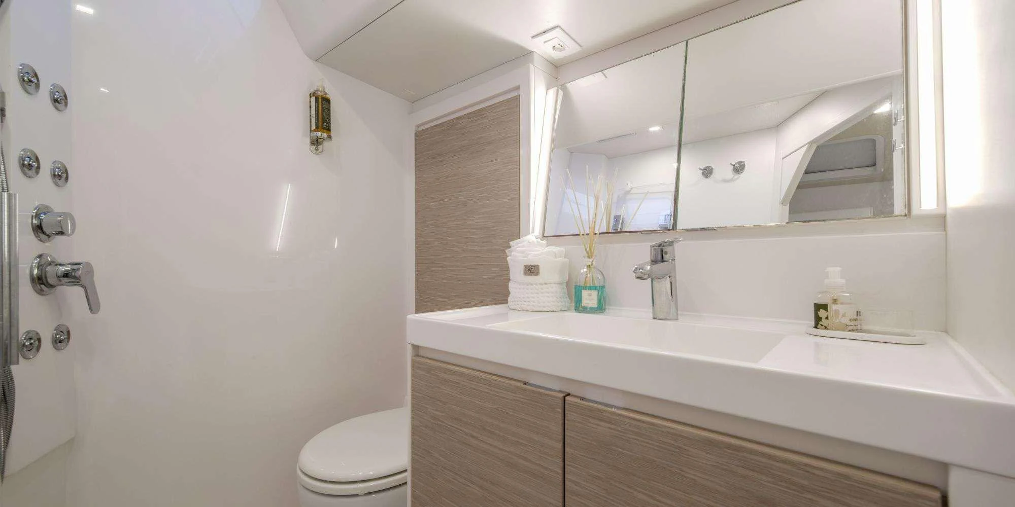 a bathroom with a sink and a mirror aboard PURA FOLLIA Yacht for Charter