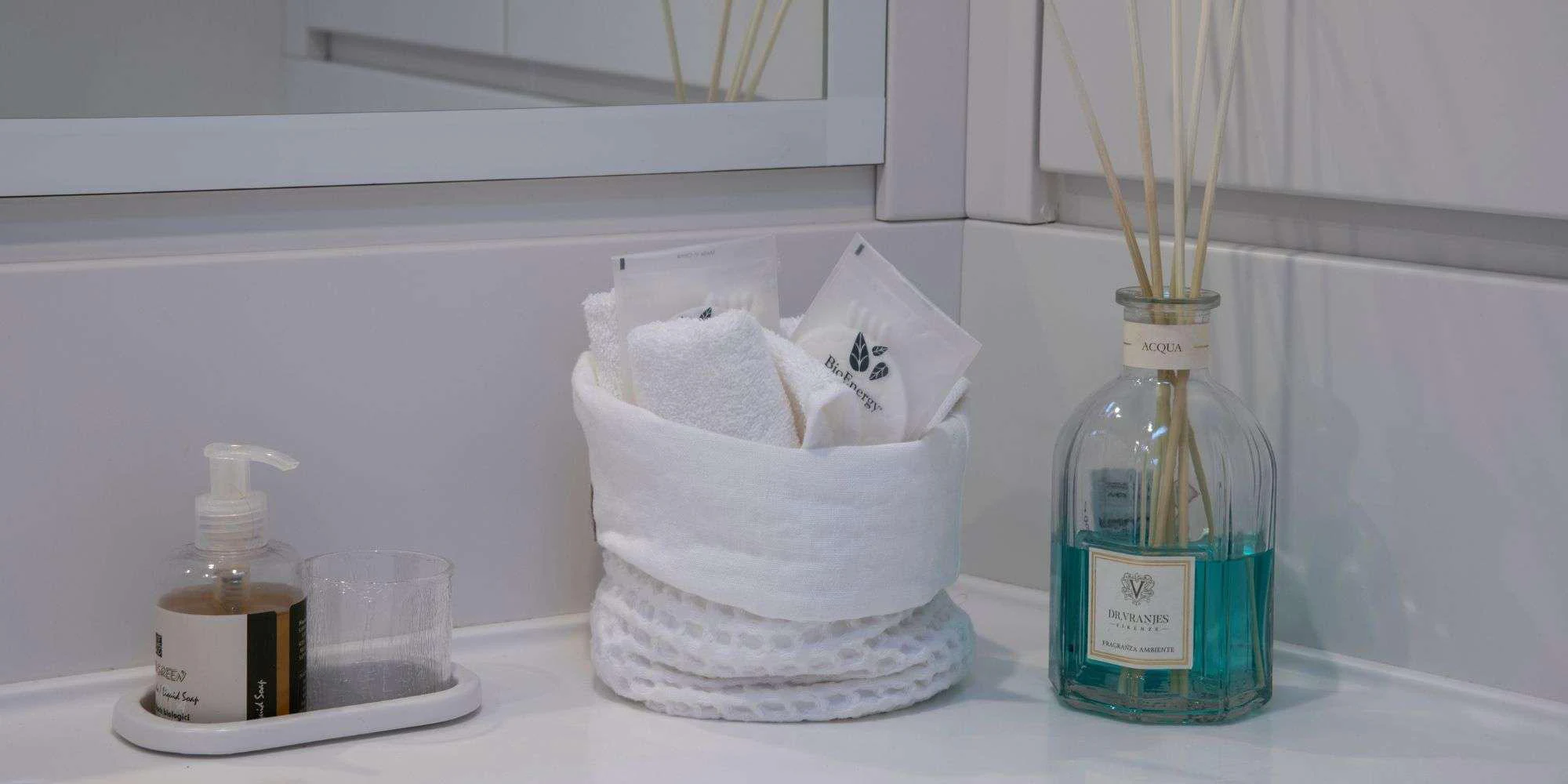 a bottle of soap and a couple of glasses of water on a shelf aboard PURA FOLLIA Yacht for Charter