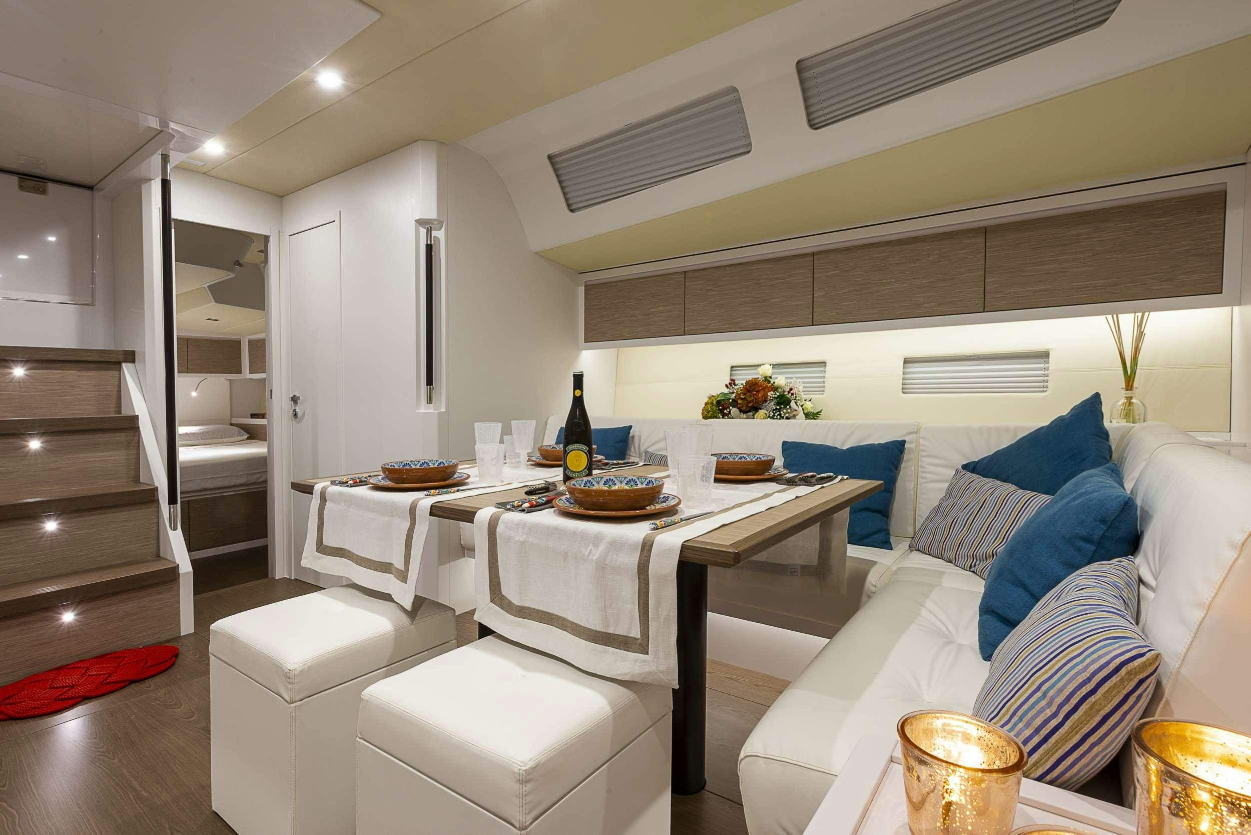 a living room with a table and chairs aboard PURA FOLLIA Yacht for Charter