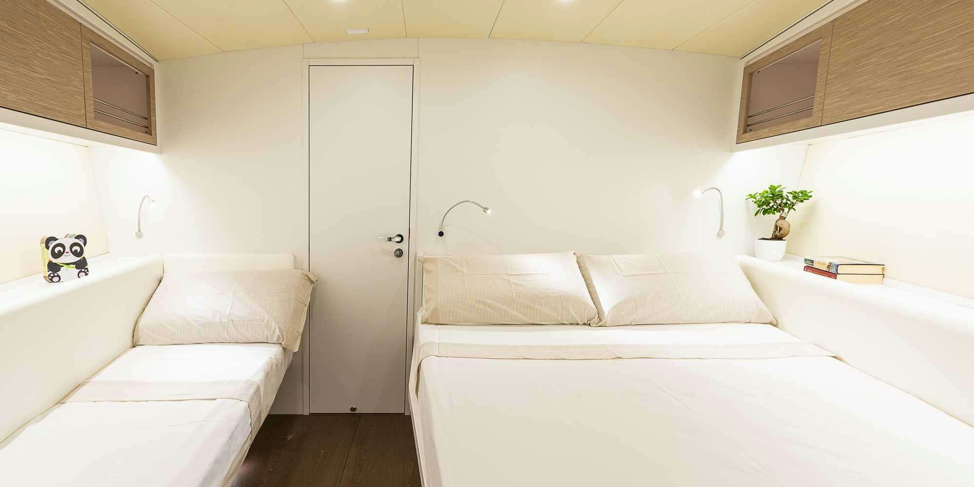 a room with white beds aboard PURA FOLLIA Yacht for Charter