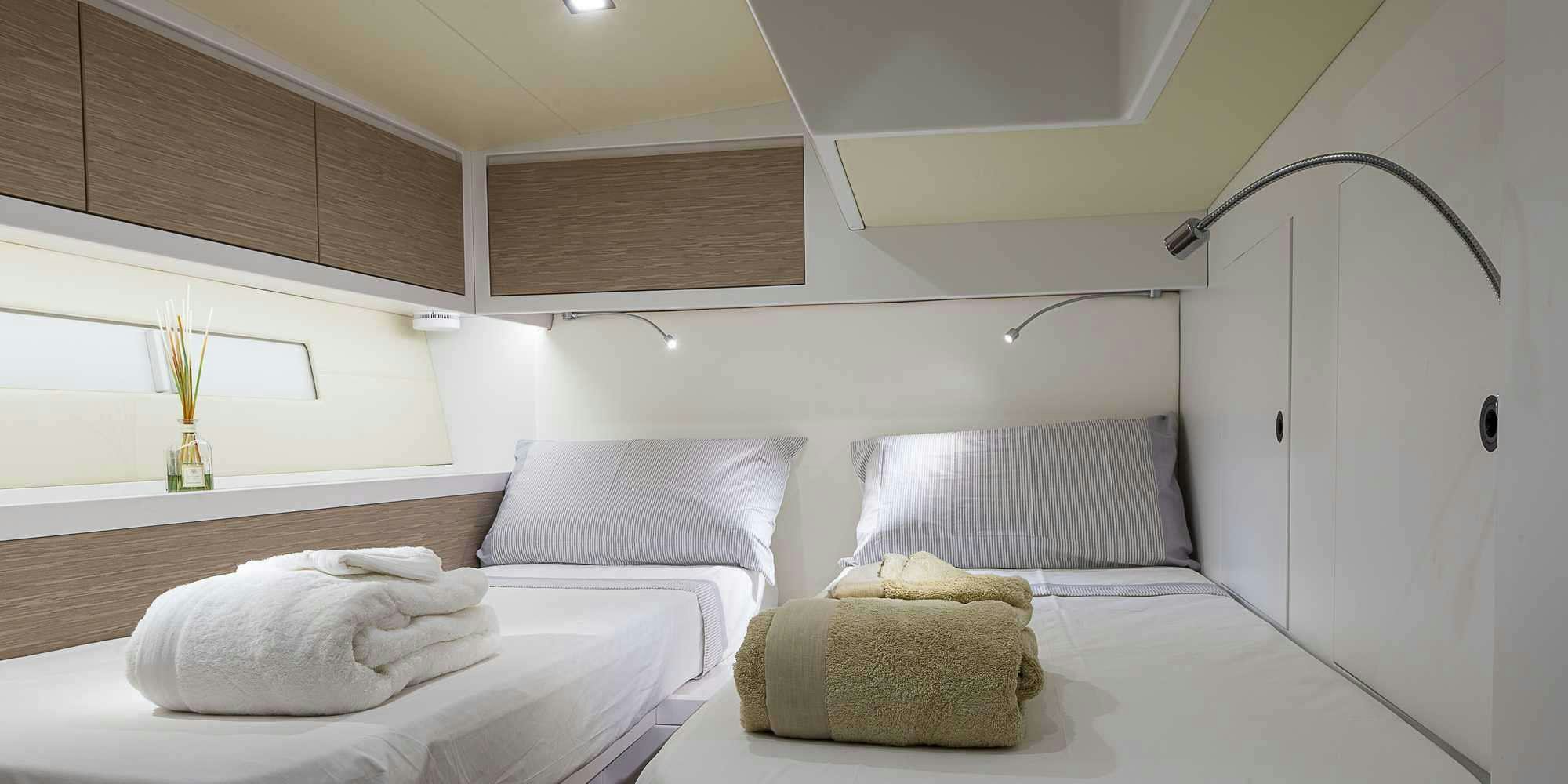 a room with two beds aboard PURA FOLLIA Yacht for Charter