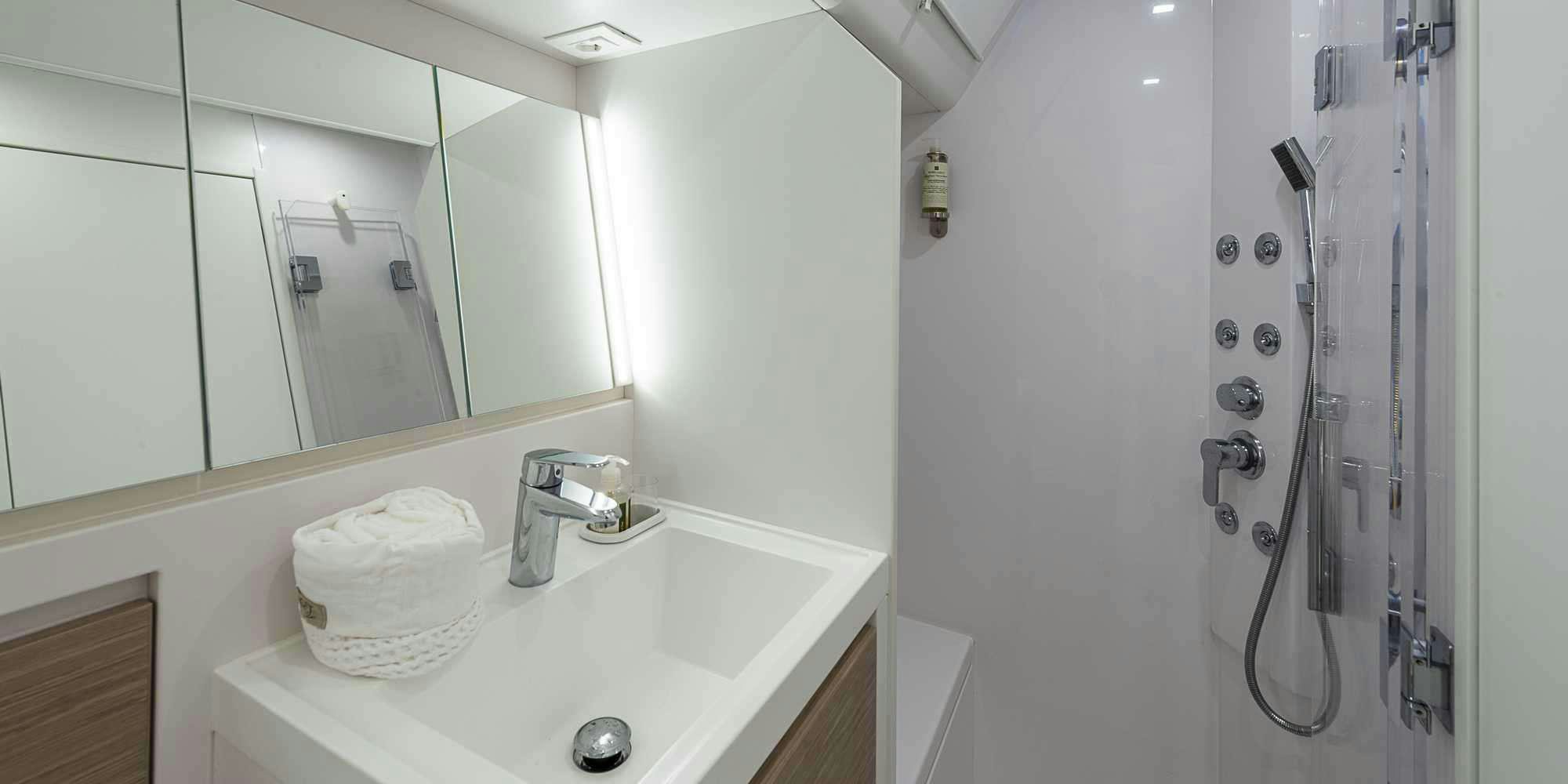 a bathroom with a large mirror aboard PURA FOLLIA Yacht for Charter