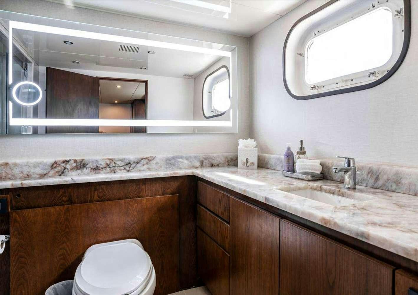 a bathroom with a sink and a toilet aboard A PLACE IN THE SUN Yacht for Charter