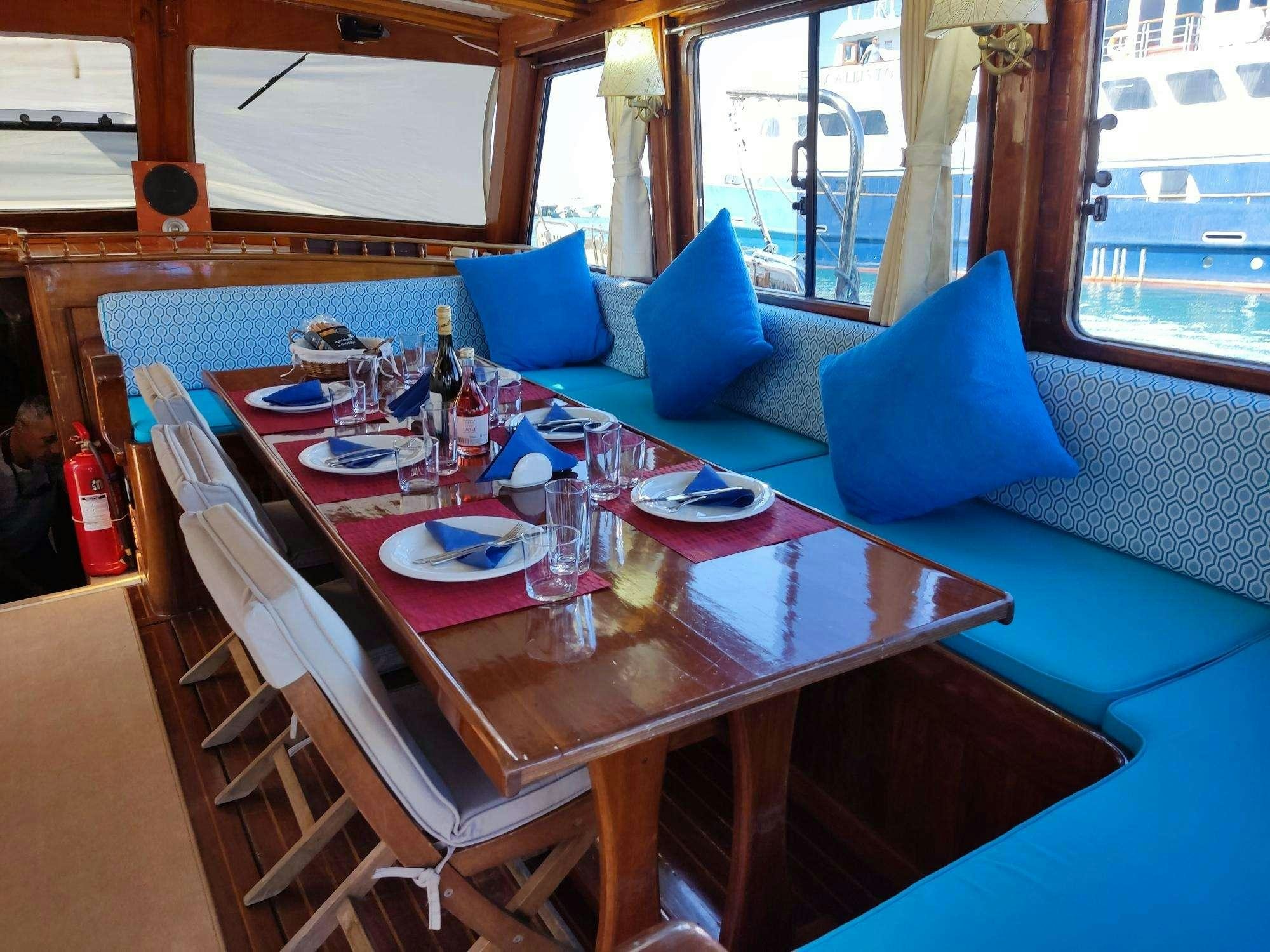 a table with plates and glasses on it aboard Stella Queen Yacht for Charter