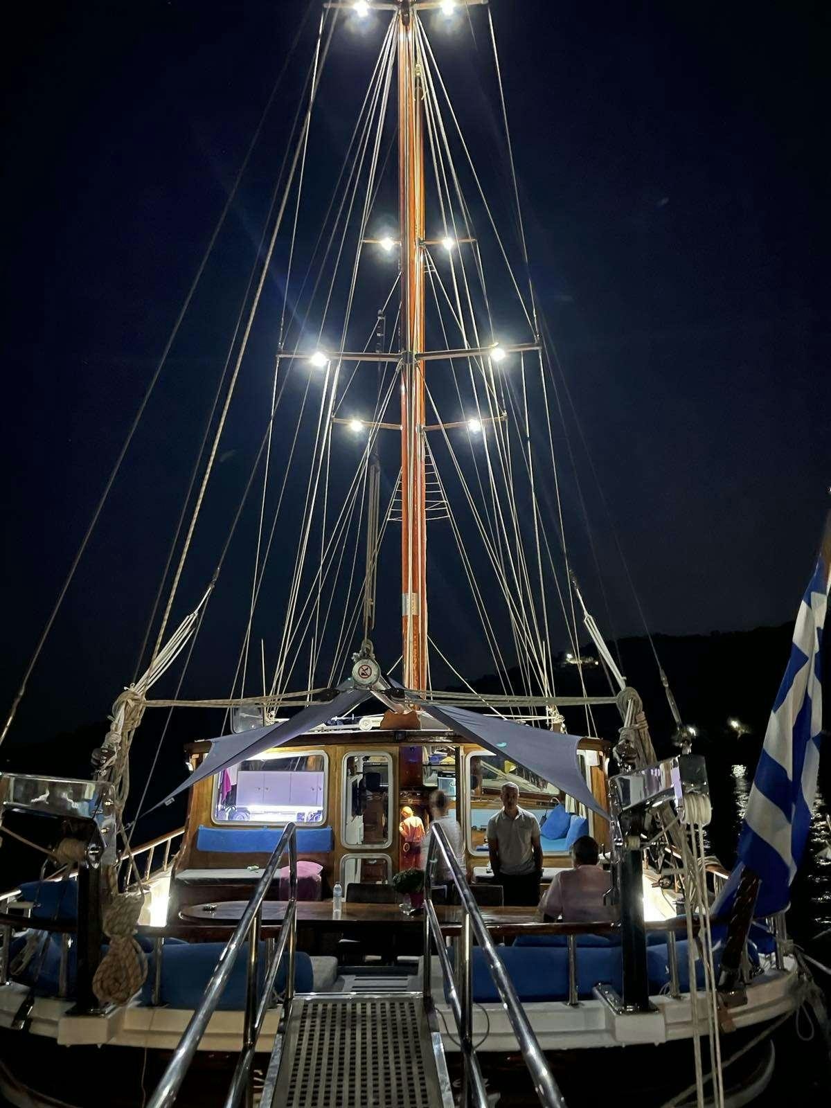 a boat with a sail on the water aboard Stella Queen Yacht for Charter