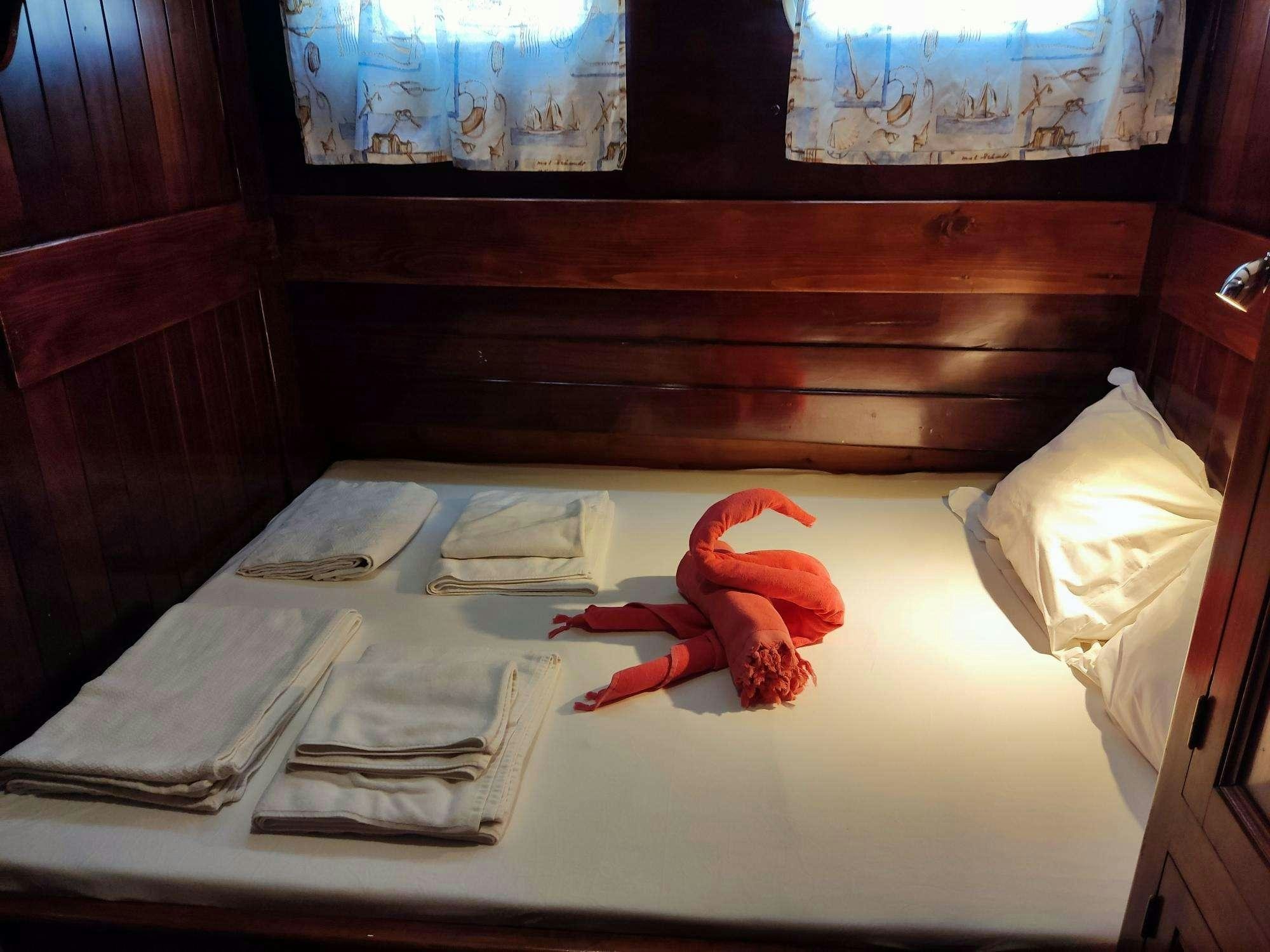 a stuffed toy on a bed aboard Stella Queen Yacht for Charter