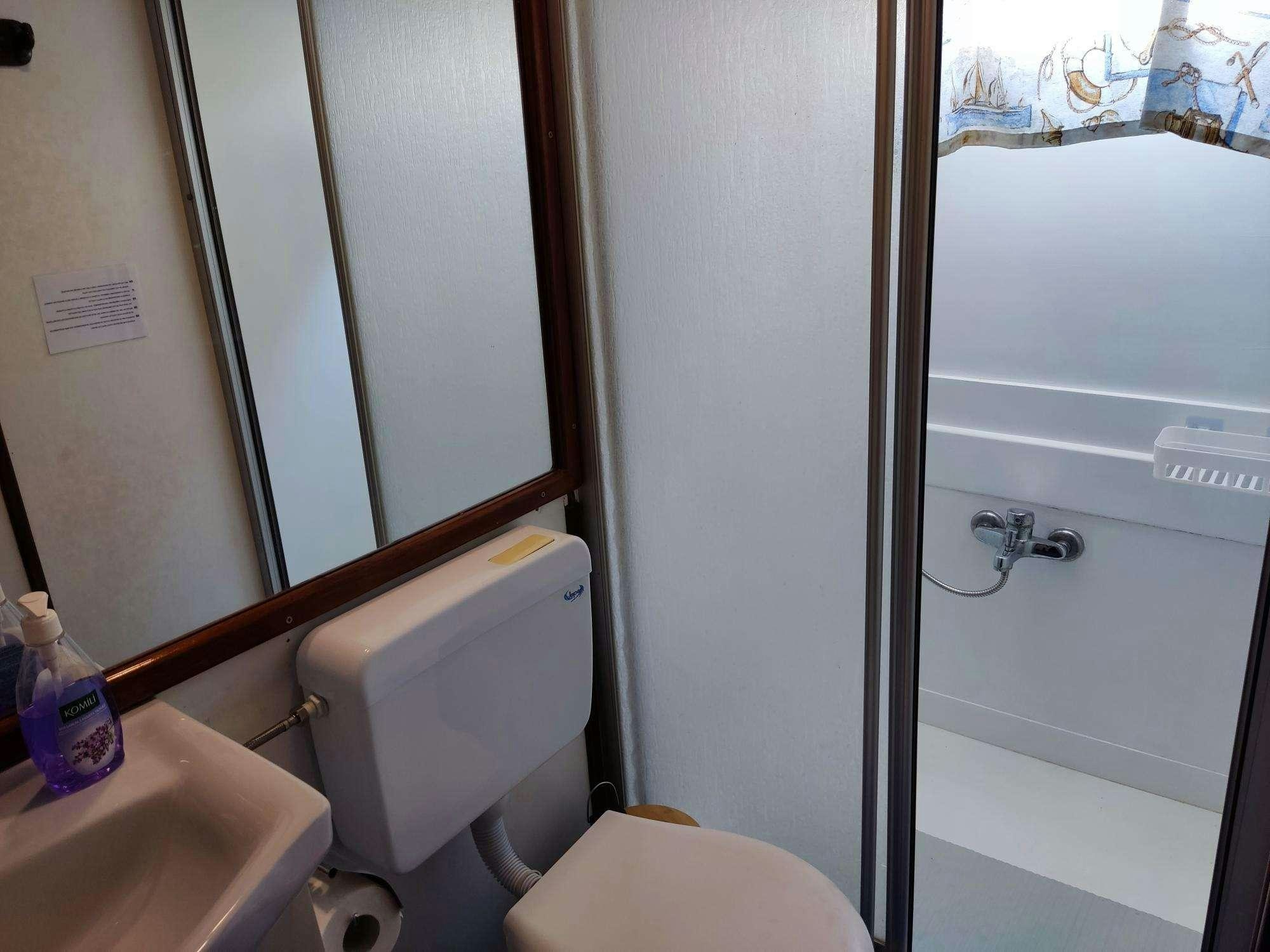 a bathroom with a toilet and sink aboard Stella Queen Yacht for Charter