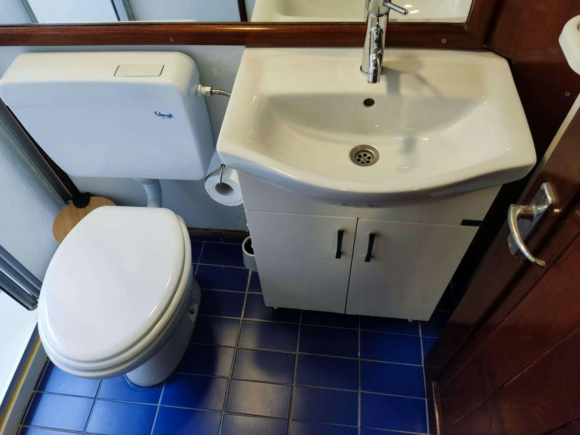 a bathroom with a sink and toilet aboard Stella Queen Yacht for Charter