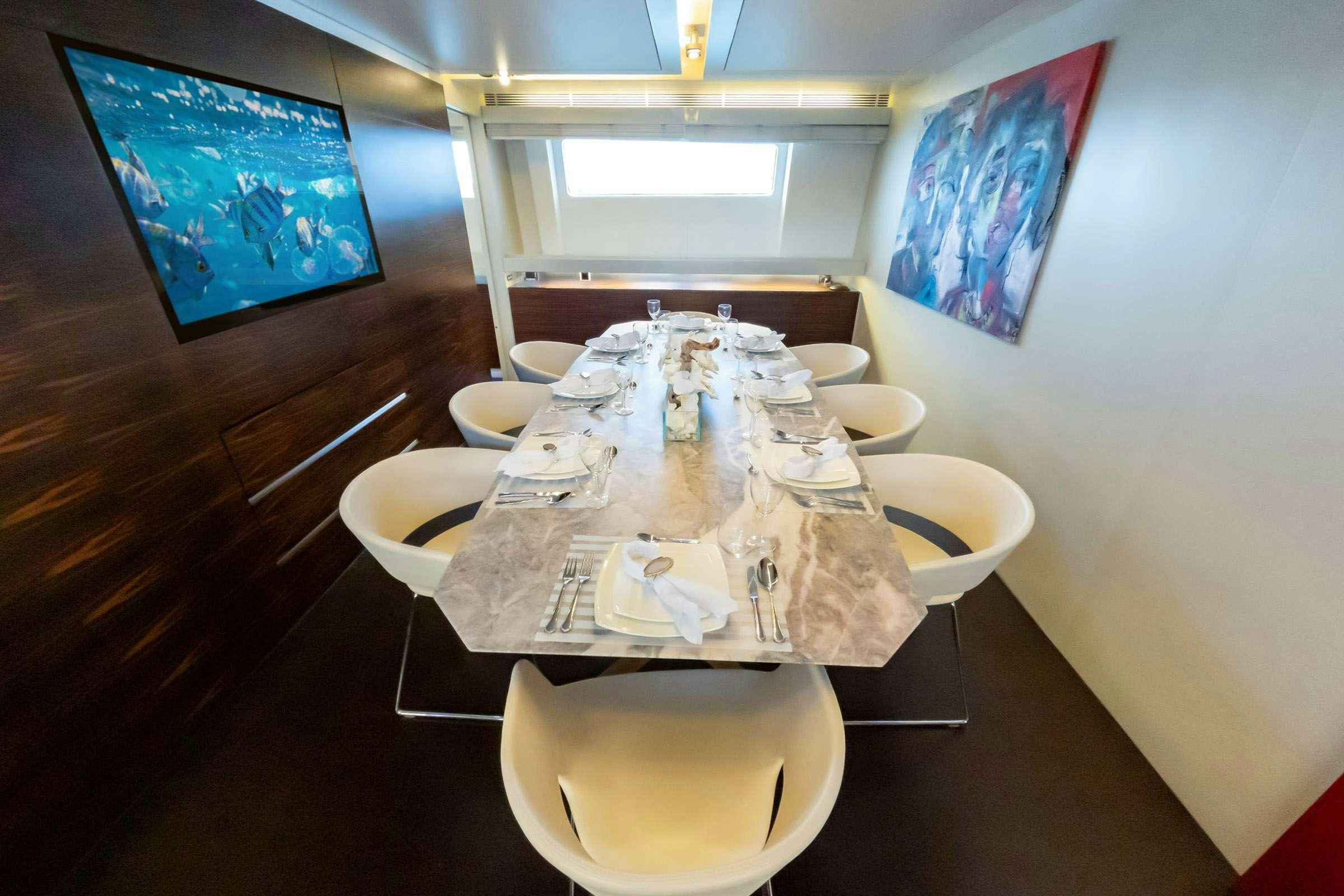 a table with plates and cups on it aboard CADA UNO  Yacht for Charter