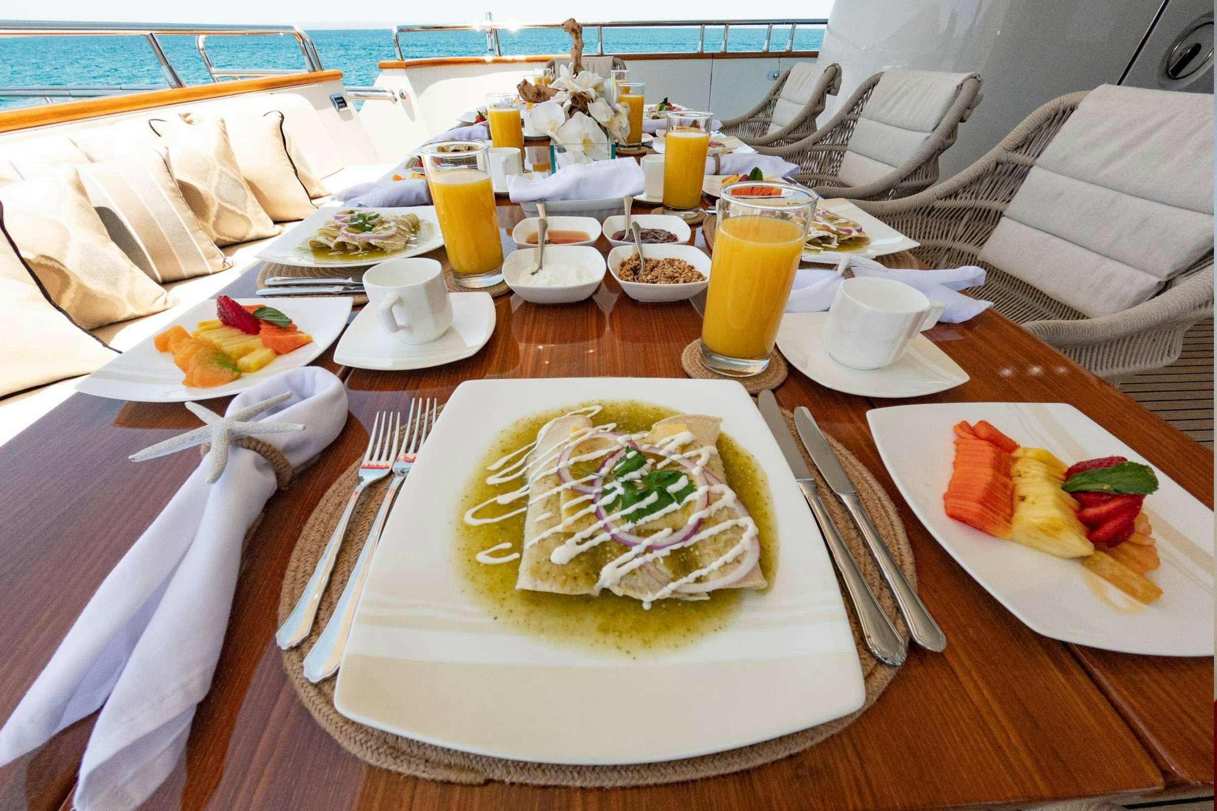 a table with food and drinks on it aboard CADA UNO  Yacht for Charter