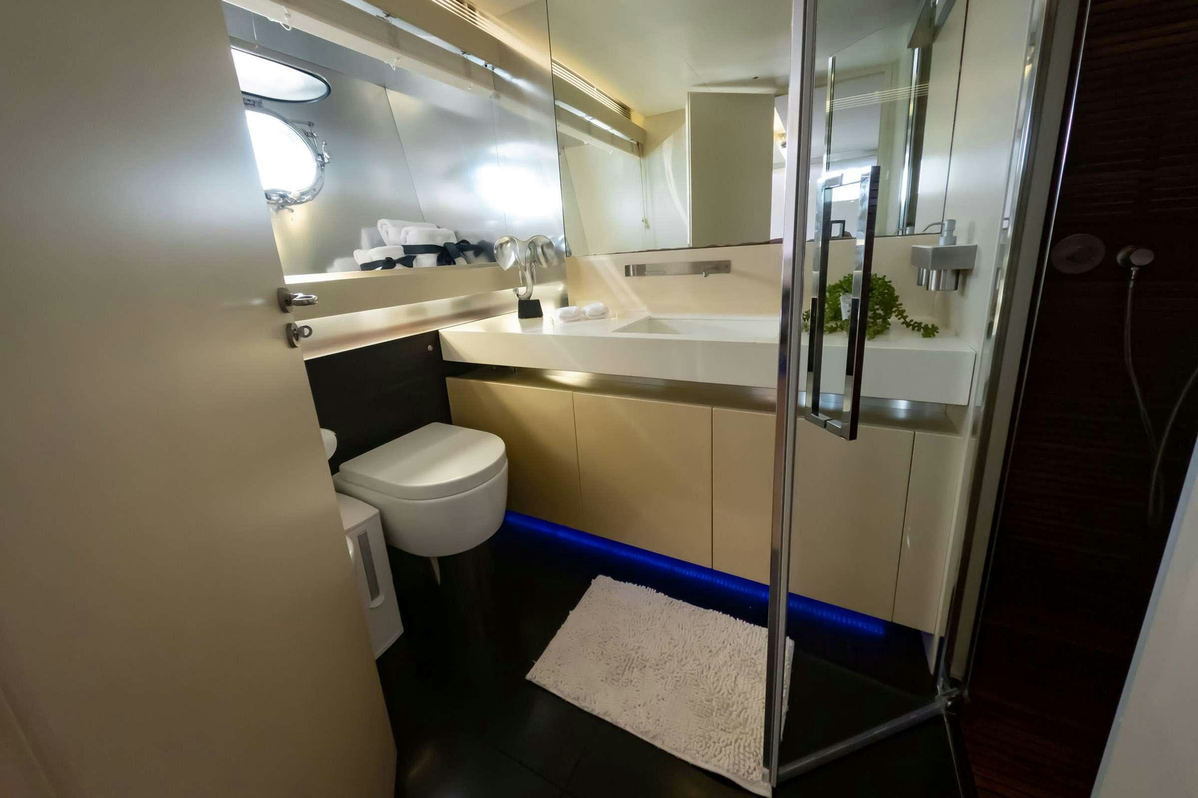 a bathroom with a glass shower aboard CADA UNO  Yacht for Charter
