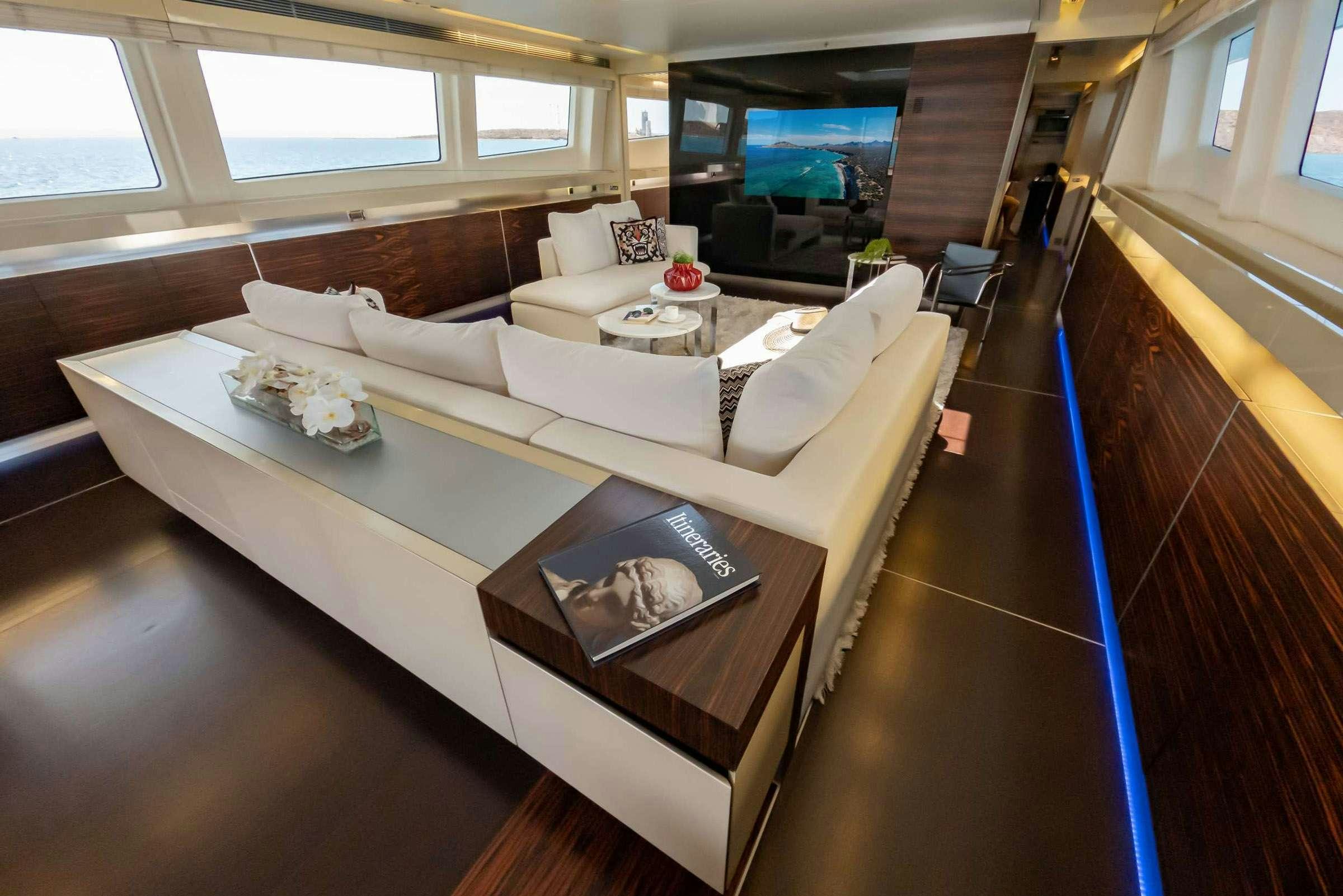a living room with a large window aboard CADA UNO  Yacht for Charter