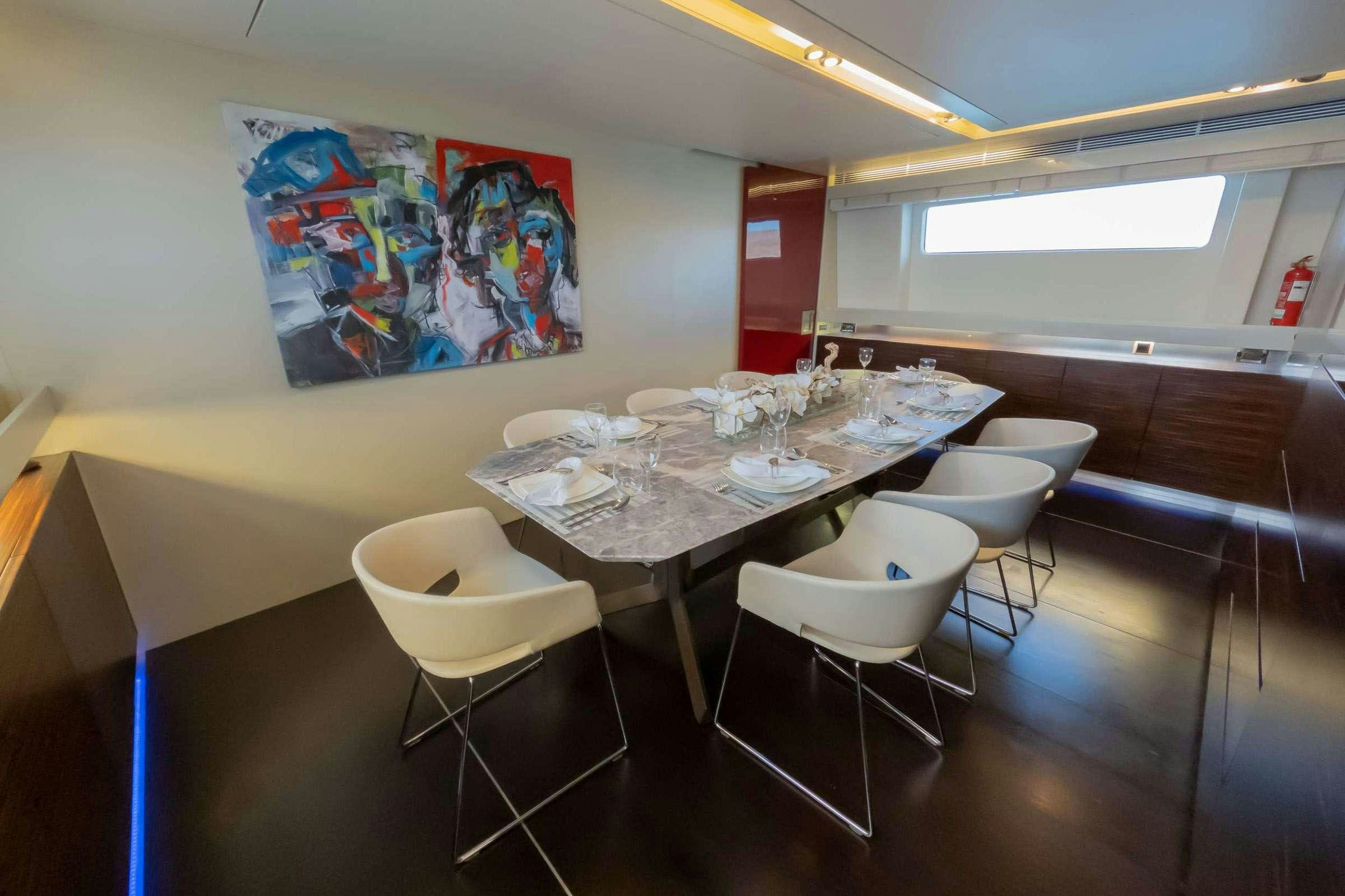 a restaurant with a table and chairs aboard CADA UNO  Yacht for Charter