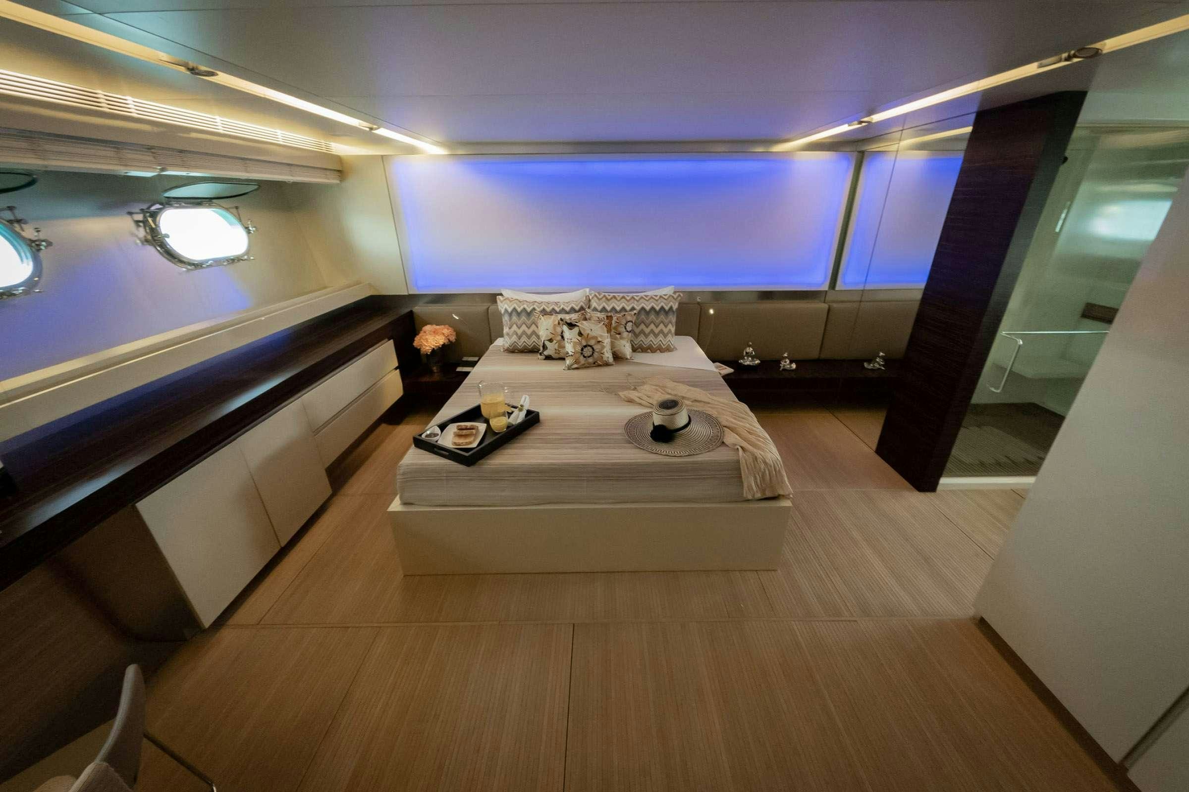a room with a bed and a laptop on the floor aboard CADA UNO  Yacht for Charter