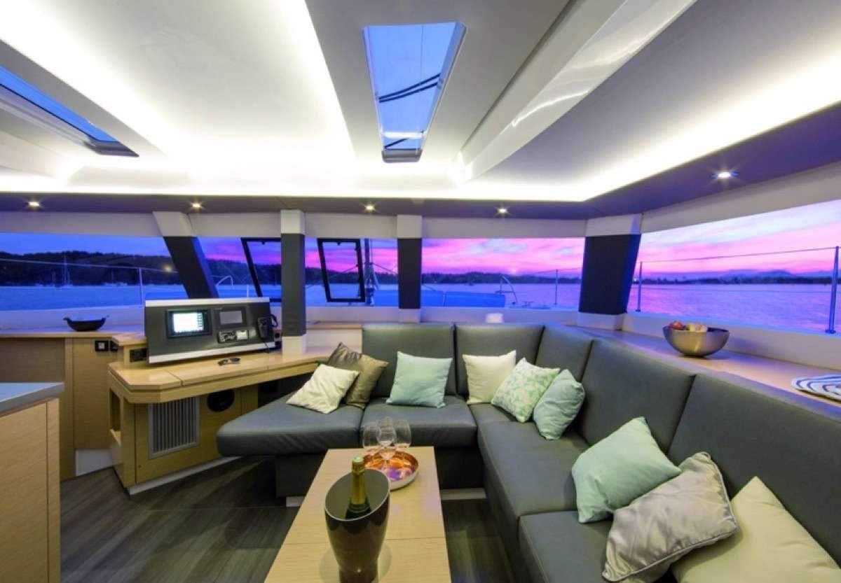 a living room with a couch and a tv aboard Daydreams Yacht for Charter