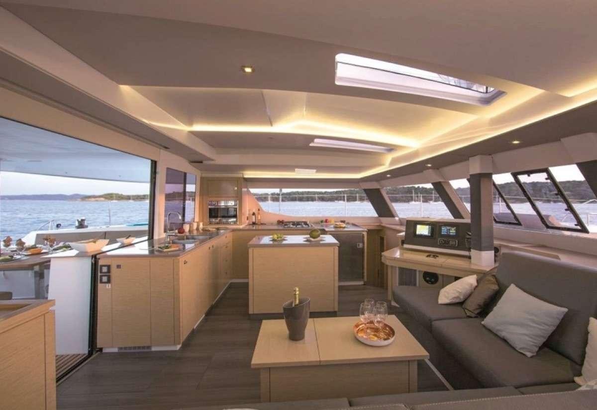 a room with a couch and a table aboard Daydreams Yacht for Charter