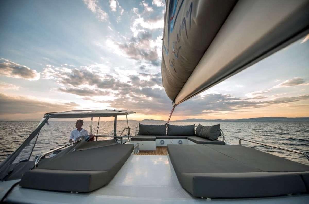 a person driving a boat on the water aboard Daydreams Yacht for Charter