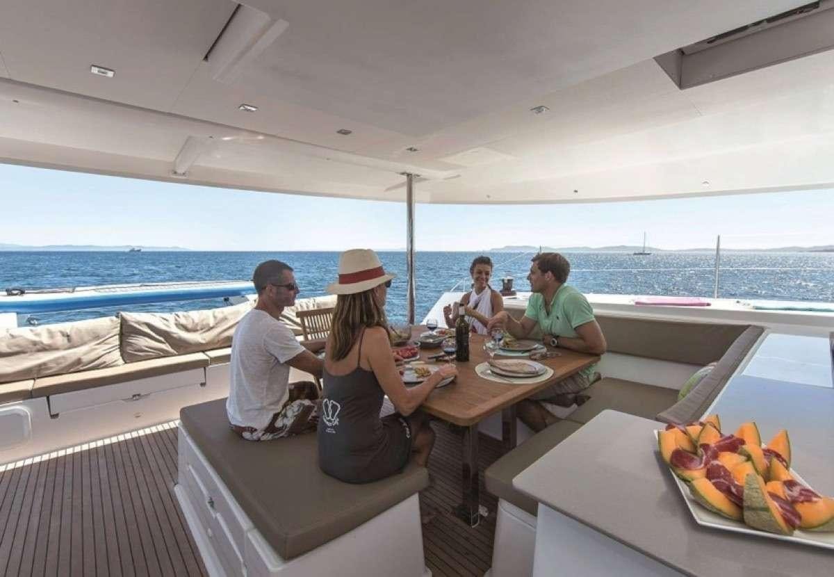 people sitting at a table aboard Daydreams Yacht for Charter