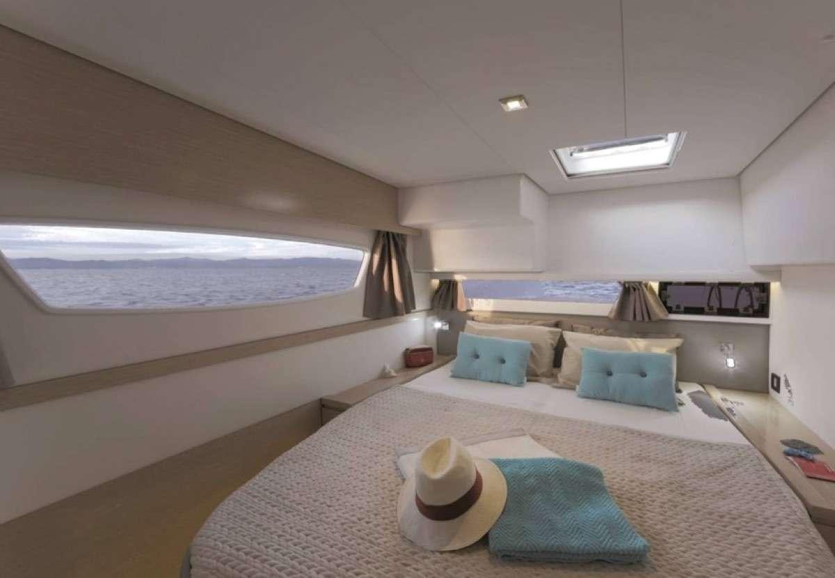 a large bedroom with a large bed aboard Daydreams Yacht for Charter