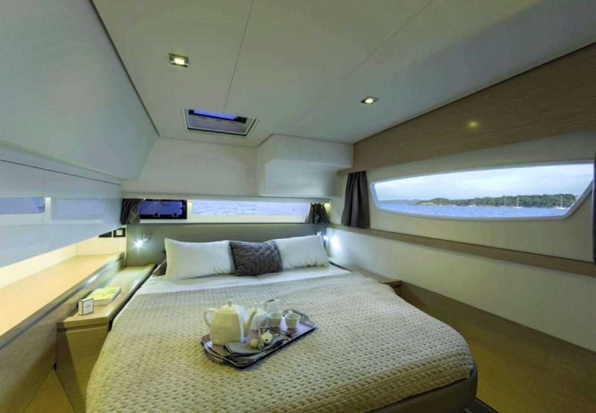 a bed with a tray on it aboard Daydreams Yacht for Charter