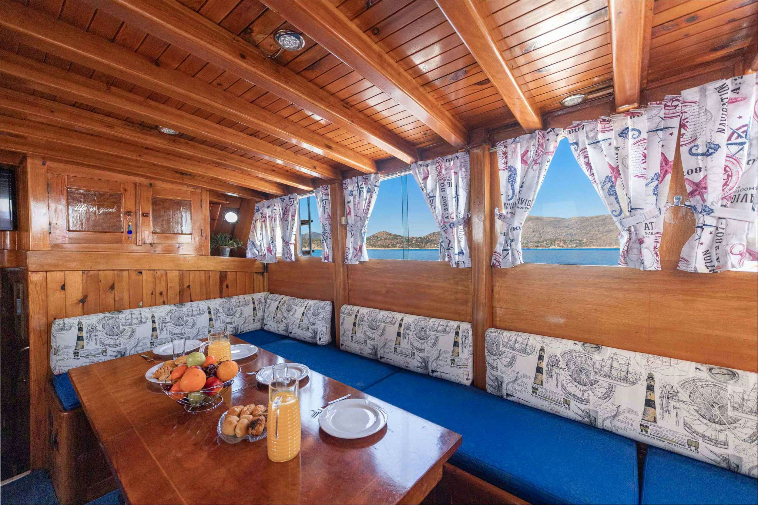 a room with a table and a bed aboard MELTEMI Yacht for Charter