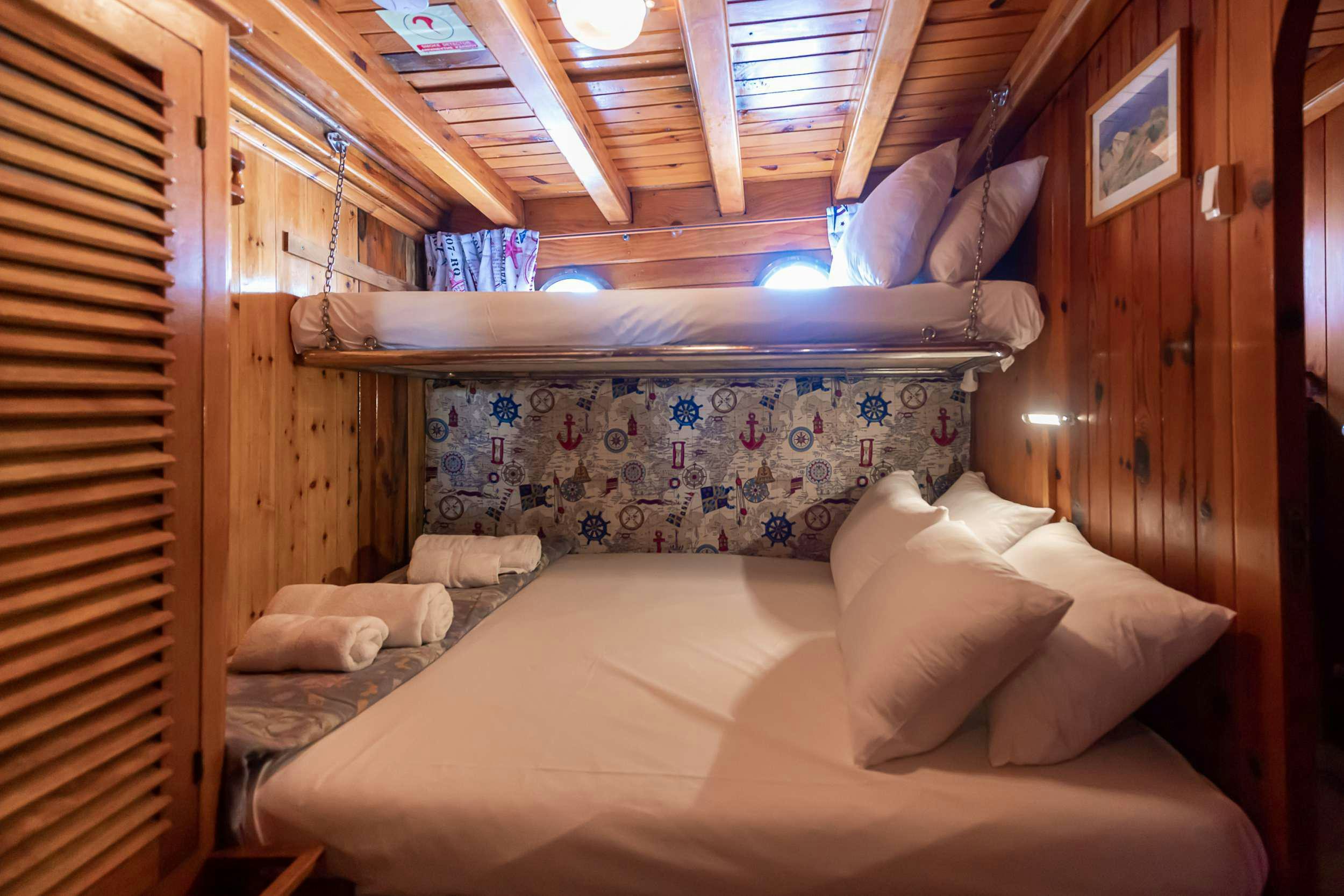 a bed with a wood frame aboard MELTEMI Yacht for Charter
