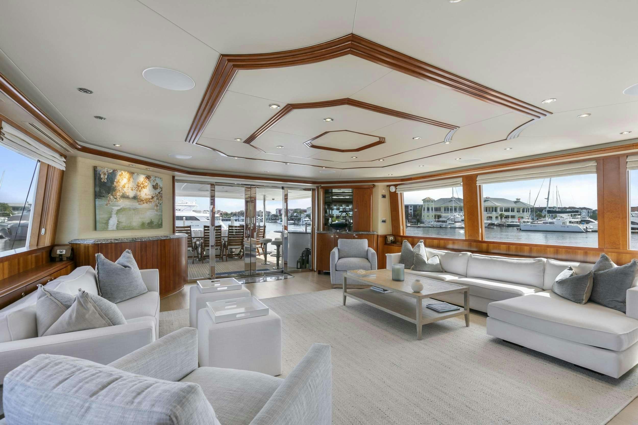 a living room with a large glass window aboard EDEN Yacht for Charter
