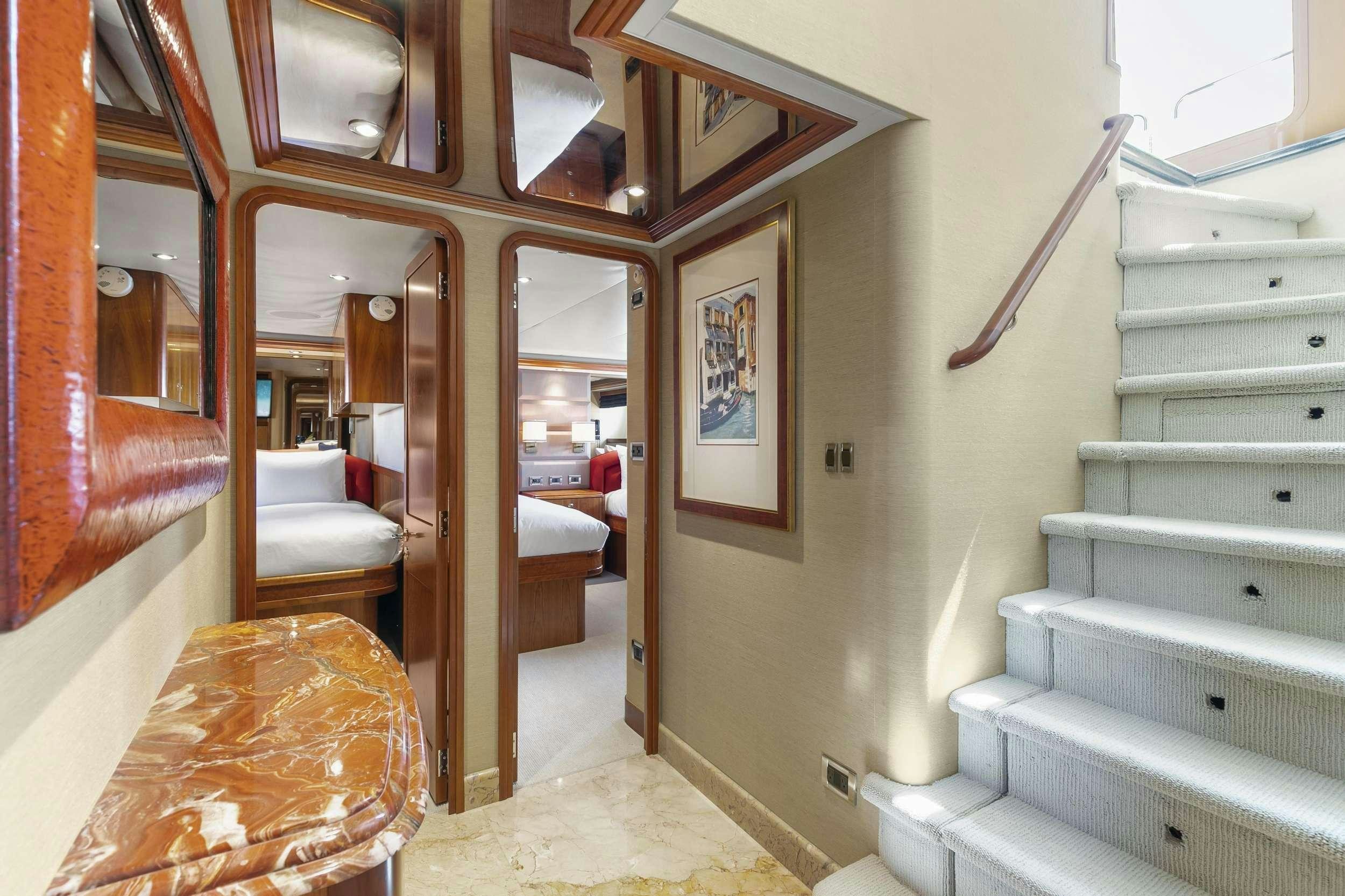 a staircase leading to a bedroom aboard EDEN Yacht for Charter