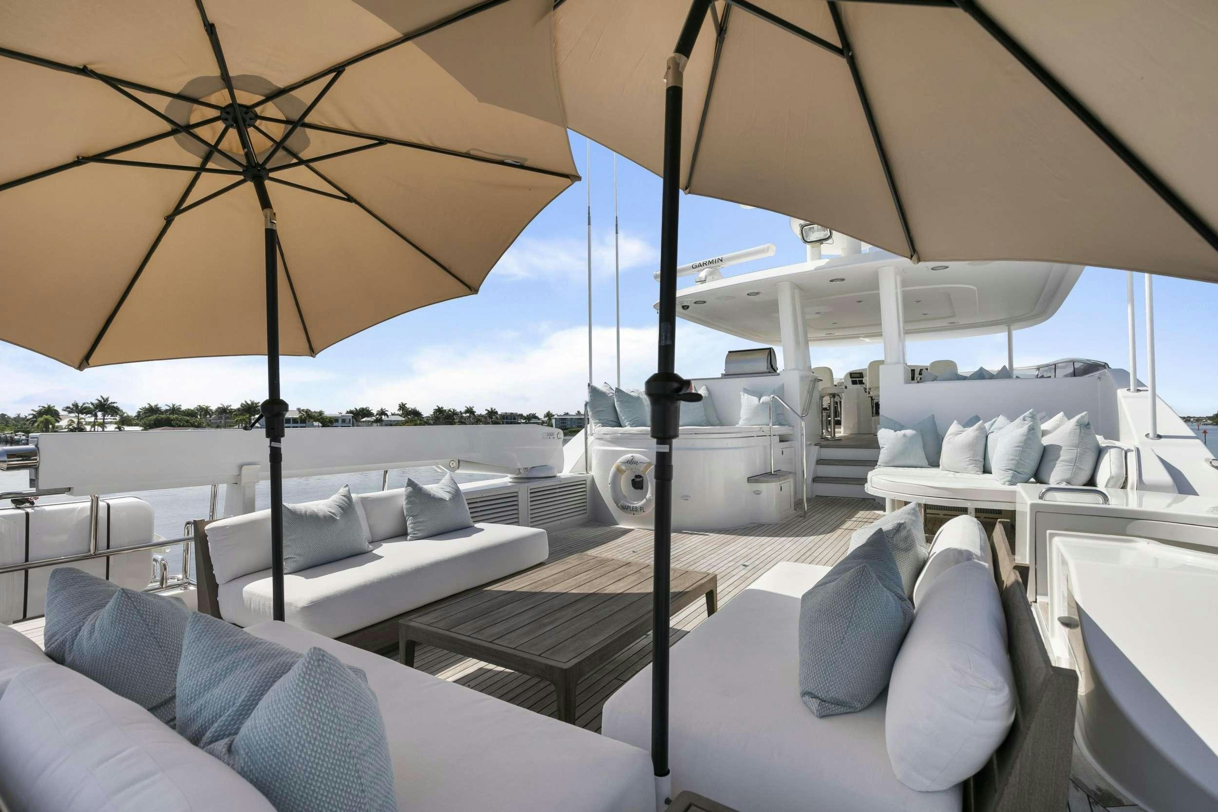 a room with tables and chairs aboard EDEN Yacht for Charter
