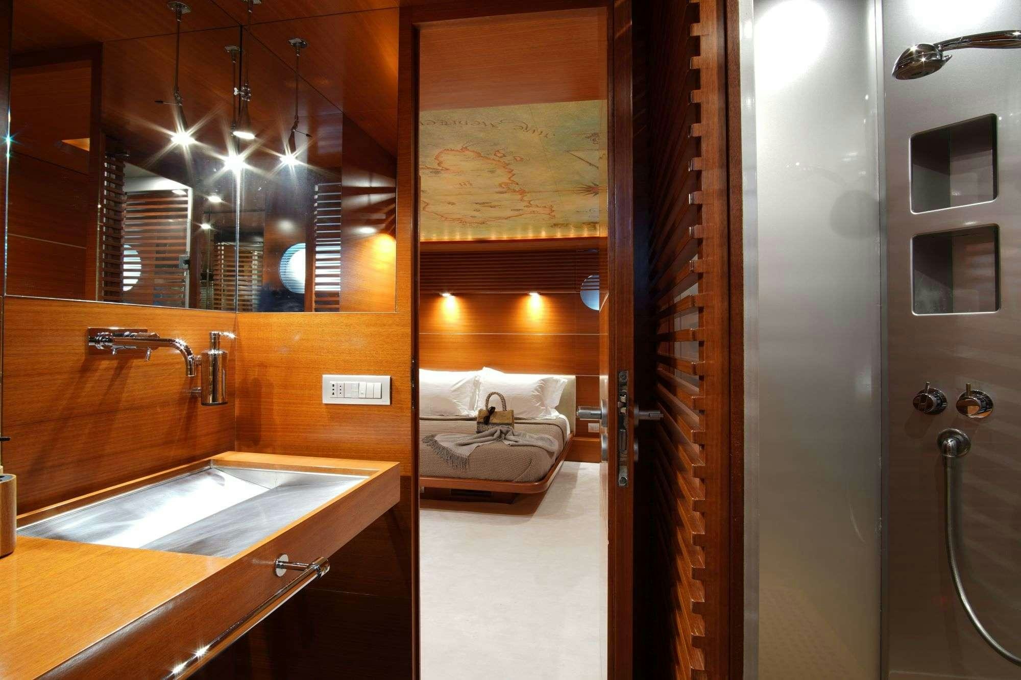 a bathroom with a sink and a bed aboard SATORI Yacht for Charter