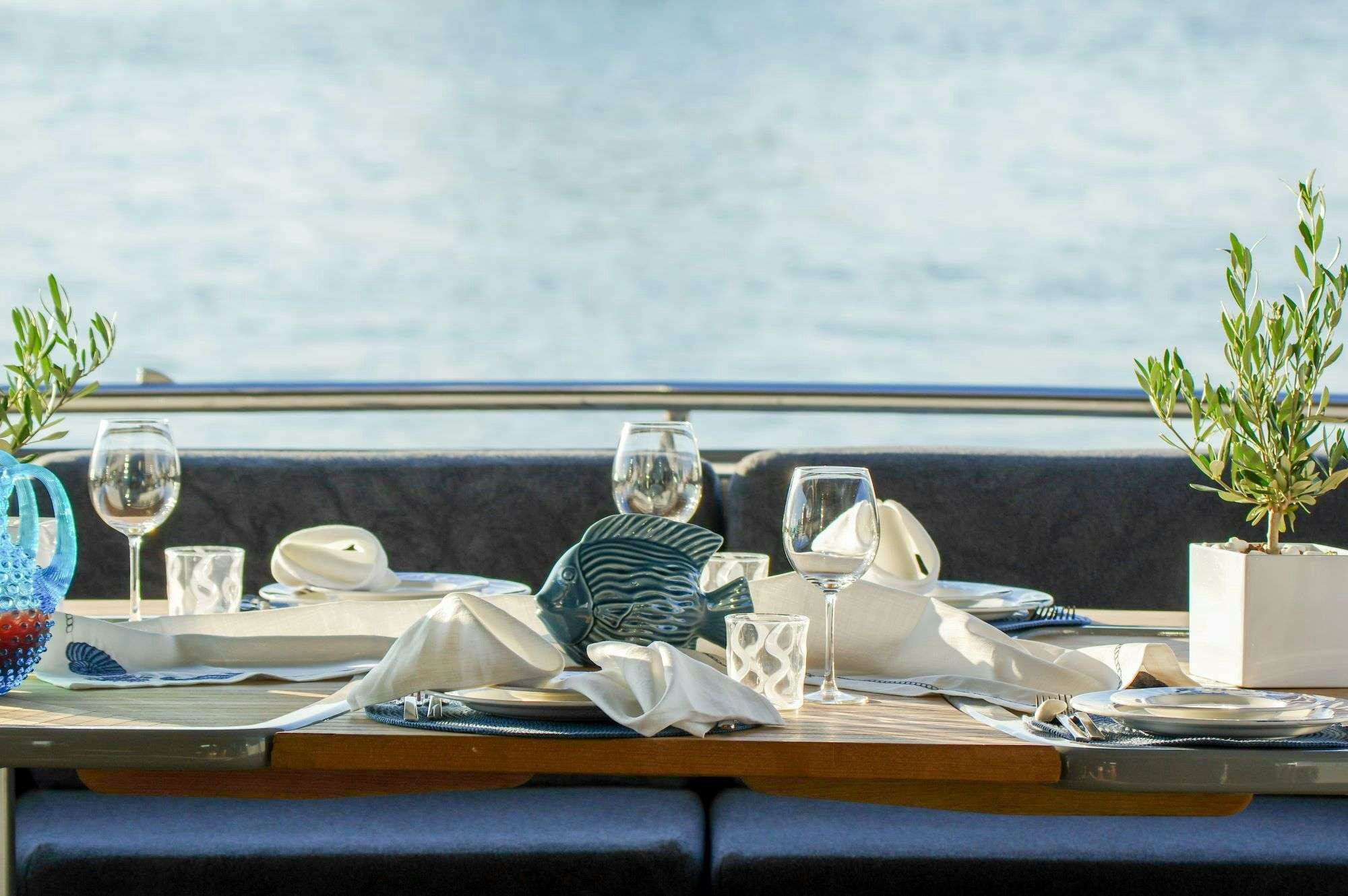a table with a cloth and glasses on it aboard SATORI Yacht for Charter
