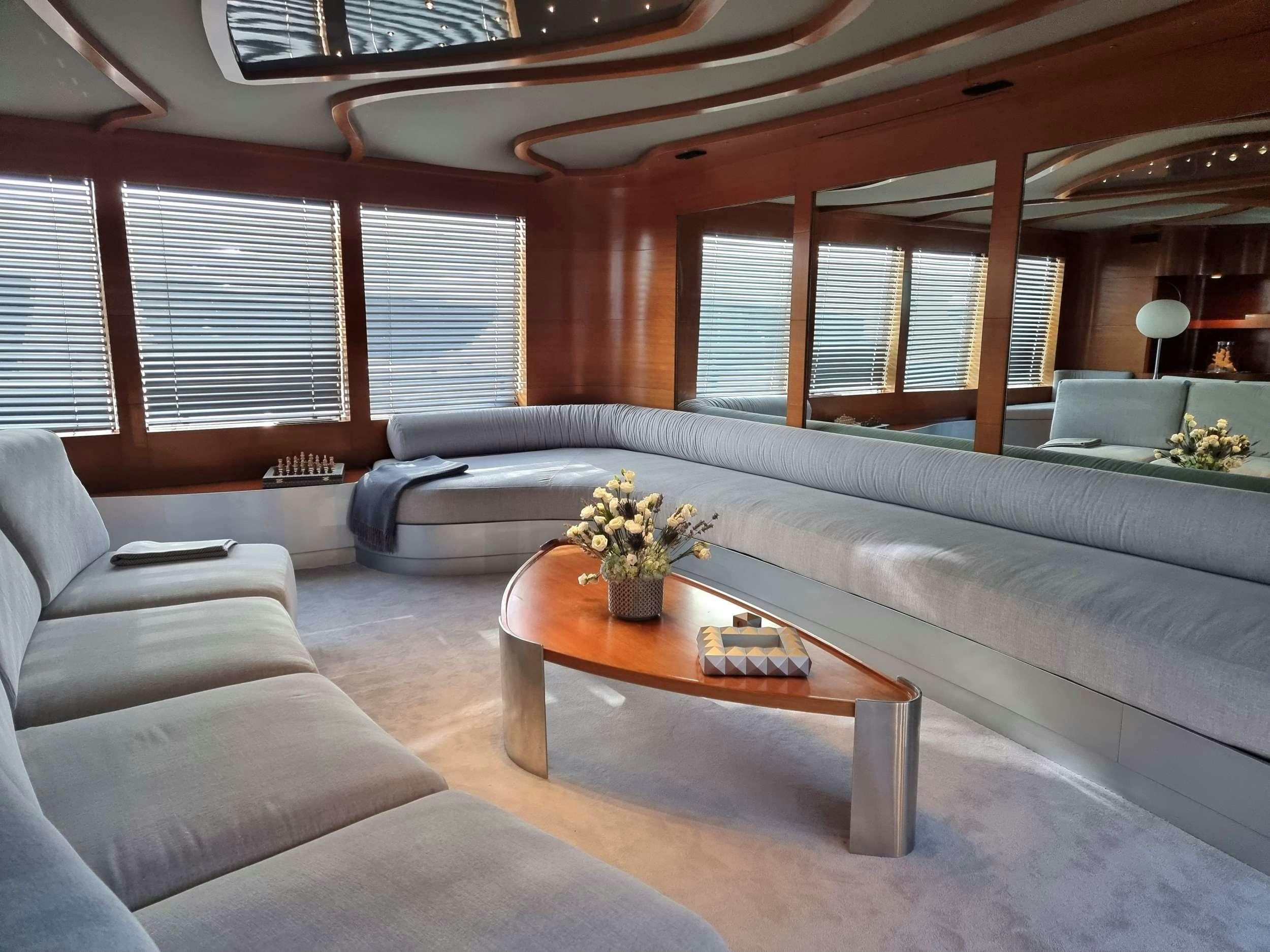 a living room with a large sofa aboard SATORI Yacht for Charter