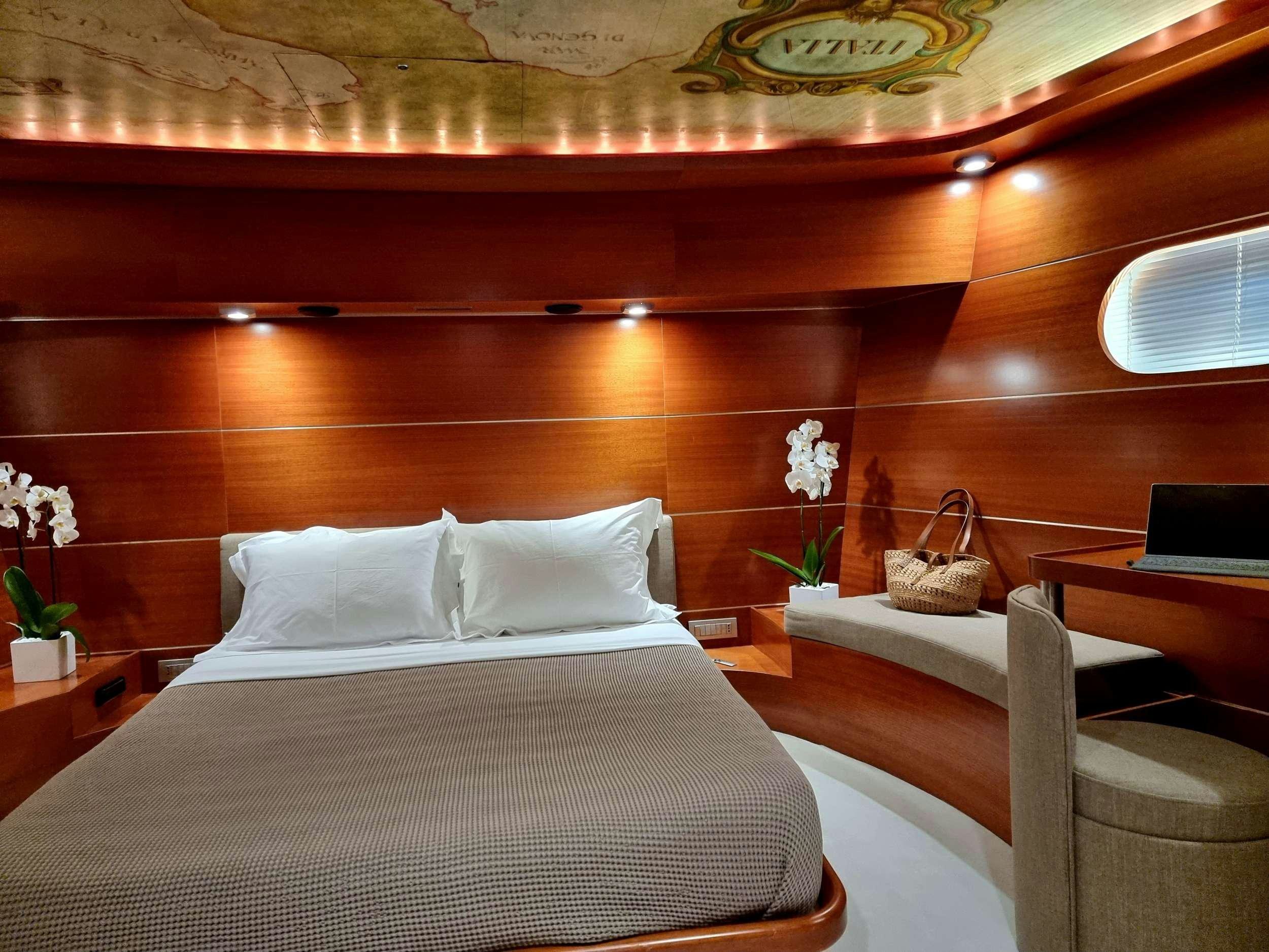 a bed with white sheets and pillows aboard SATORI Yacht for Charter