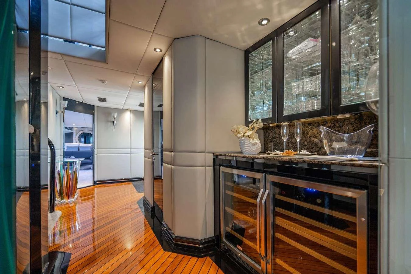 a kitchen with glass cabinets aboard QUANTUM Yacht for Charter