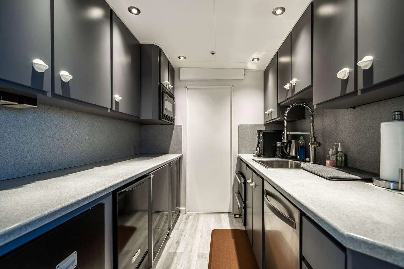a kitchen with a sink and cabinets aboard QUANTUM Yacht for Charter