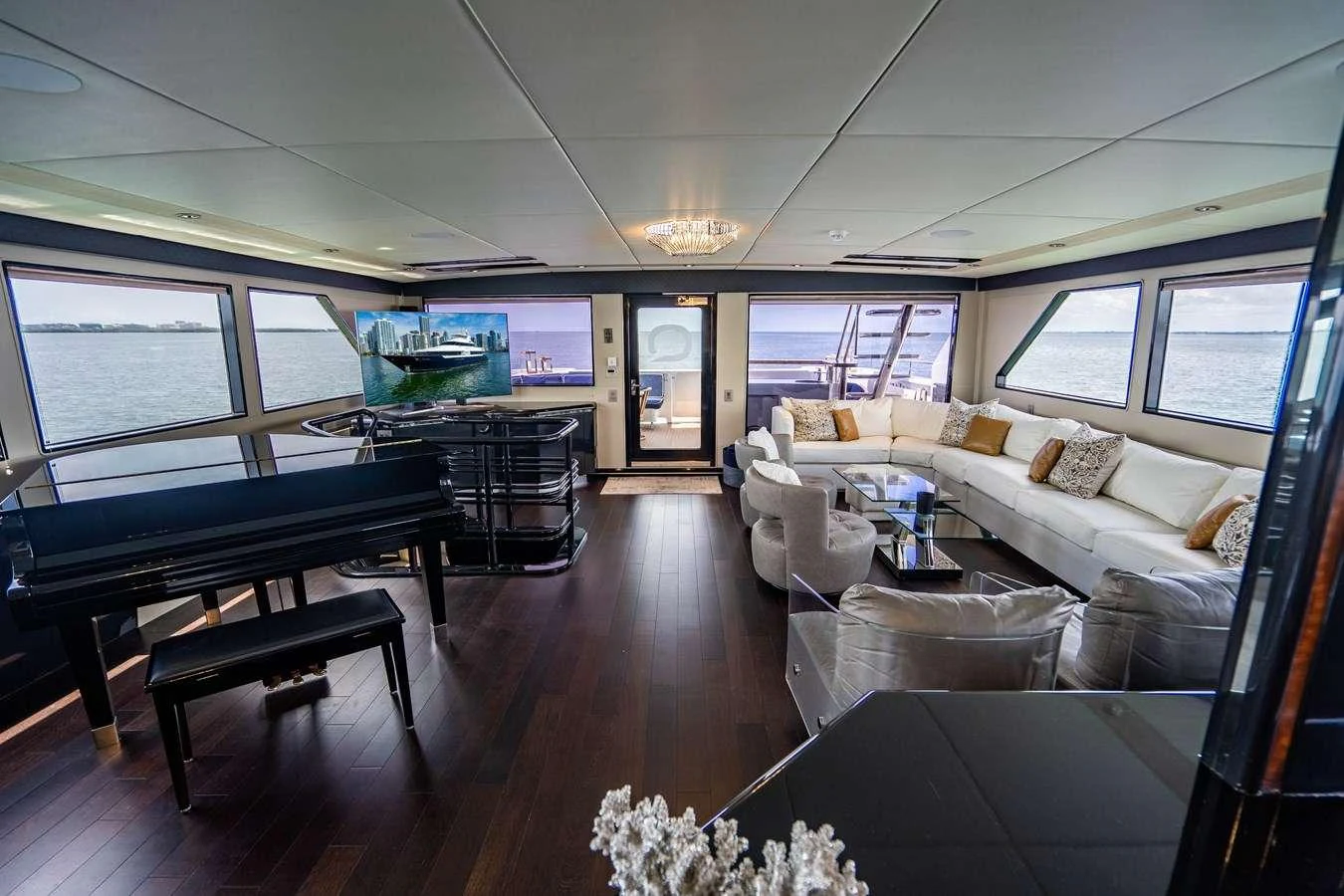 a living room with a large window aboard QUANTUM Yacht for Charter