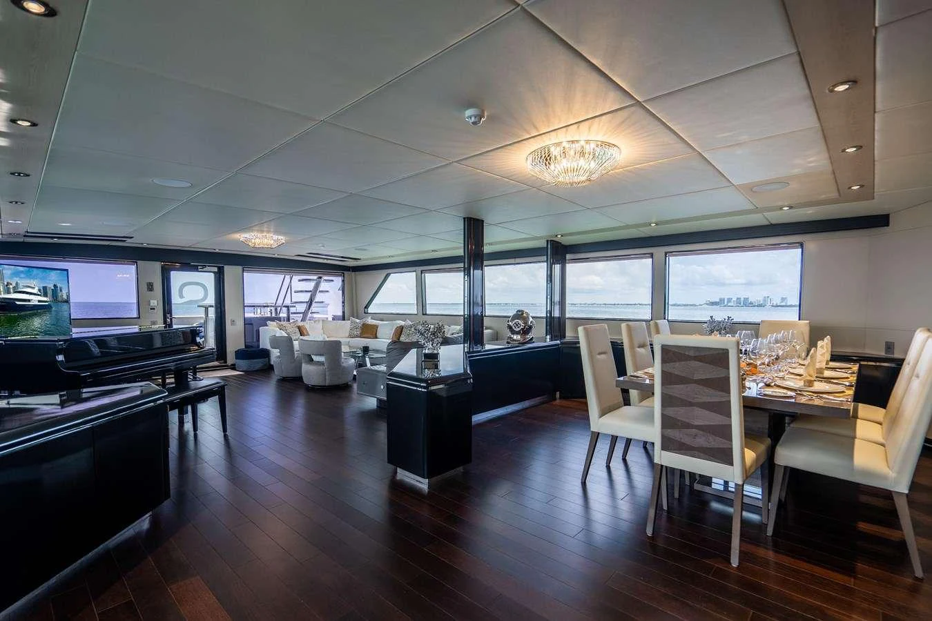a room with a table chairs and a tv aboard QUANTUM Yacht for Charter