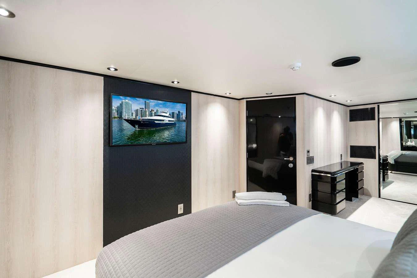 a hotel room with a tv on the wall aboard QUANTUM Yacht for Charter