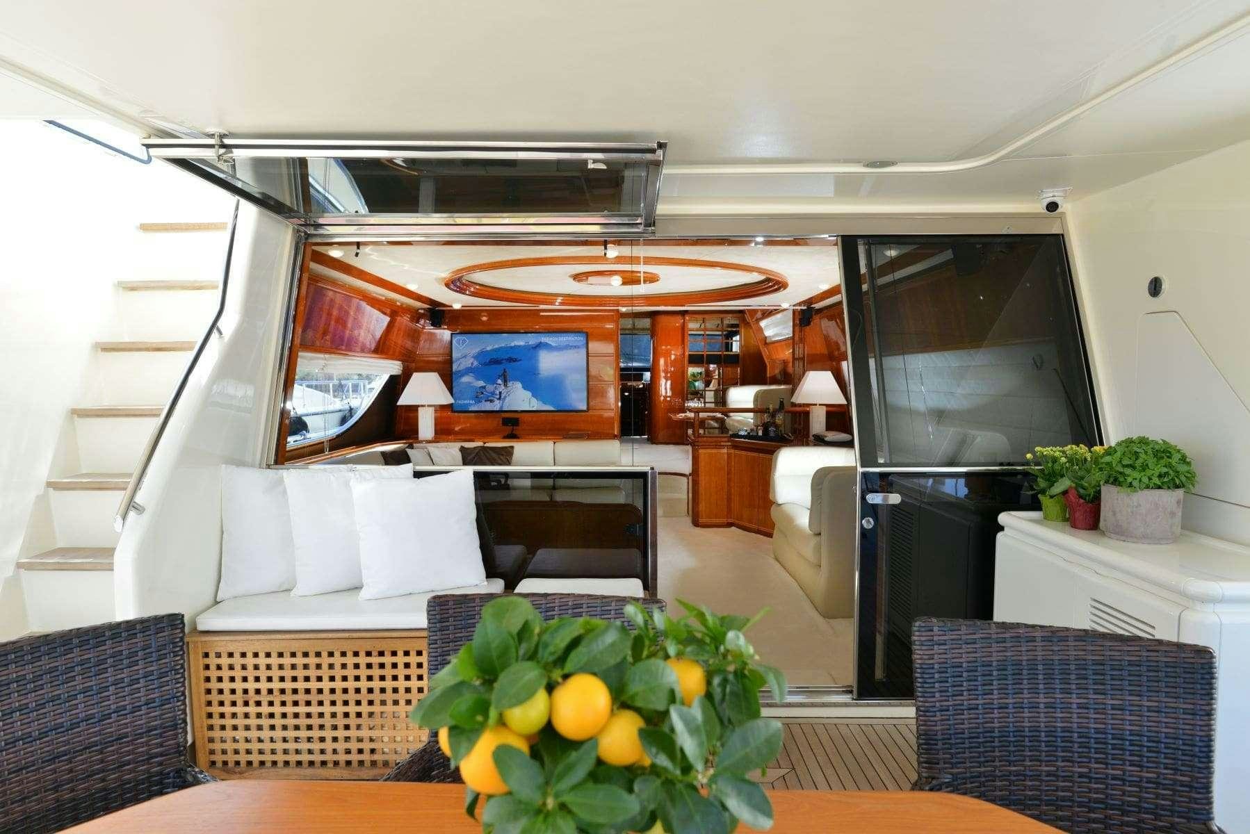a room with a tv and furniture aboard KENTAVROS II Yacht for Charter