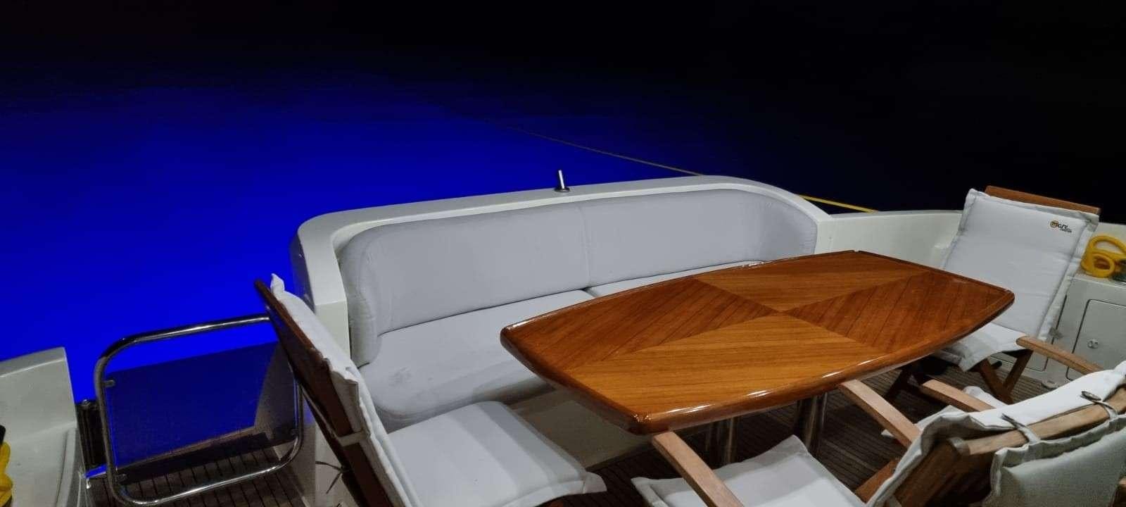 a wooden table with chairs around it aboard SEA LA VIE Yacht for Charter