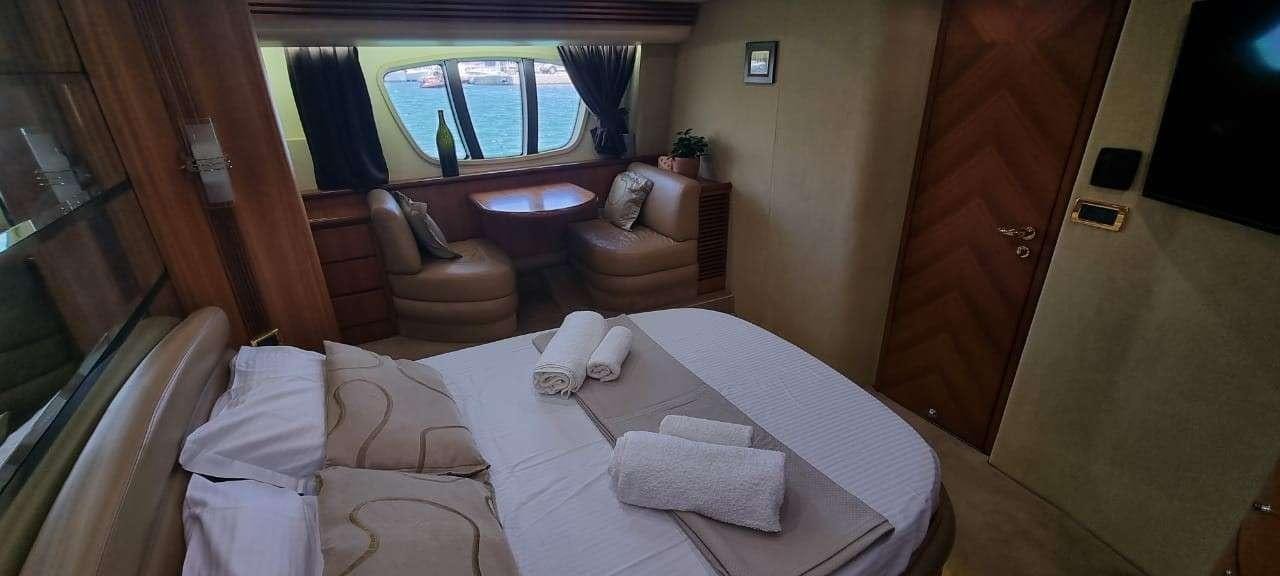 a hotel room with a bed and chairs aboard SEA LA VIE Yacht for Charter